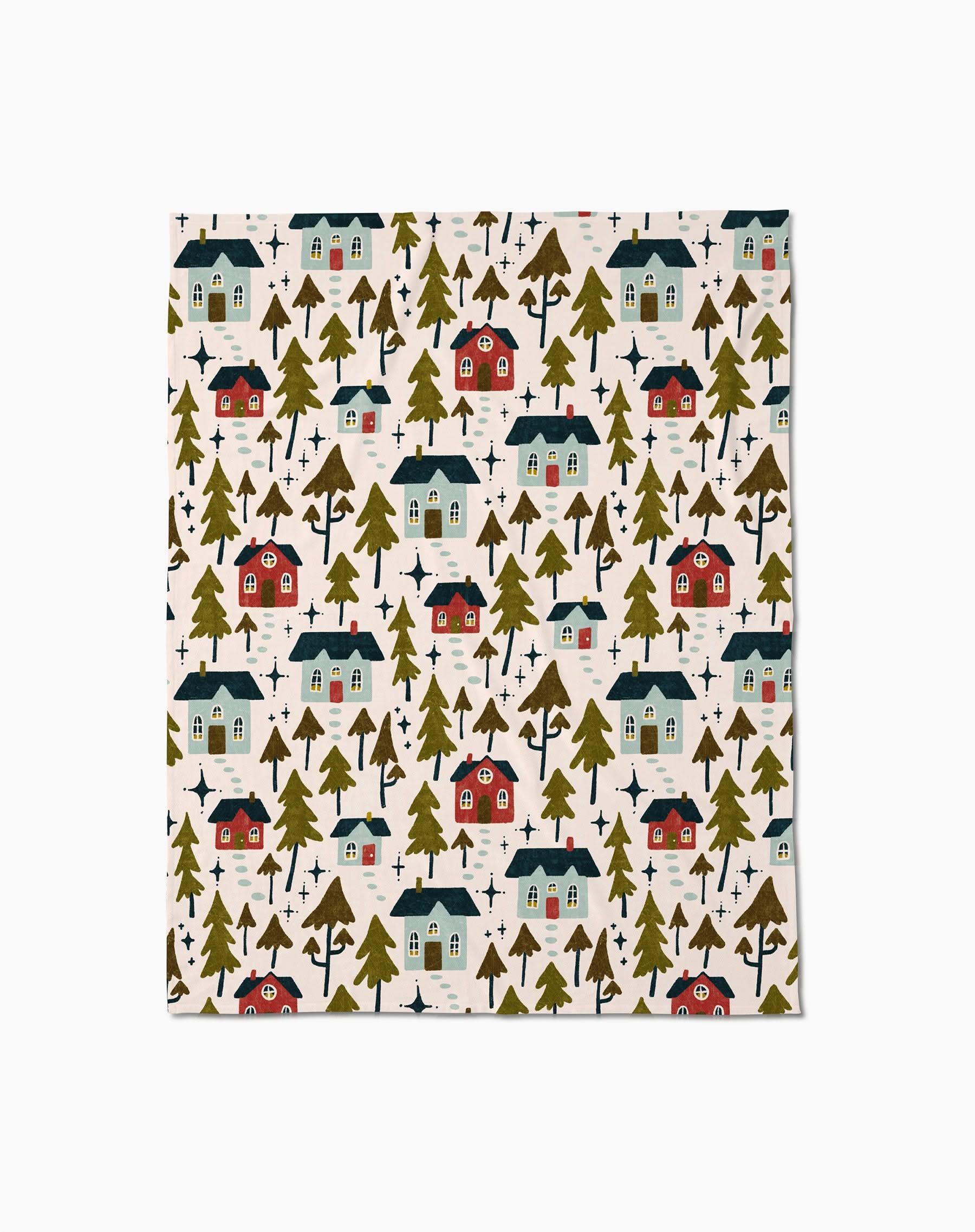 The Amy MacCready Nico Light is a silky soft blanket made from recycled materials, featuring a patterned cloth with small red and blue houses and green trees on a light beige background.