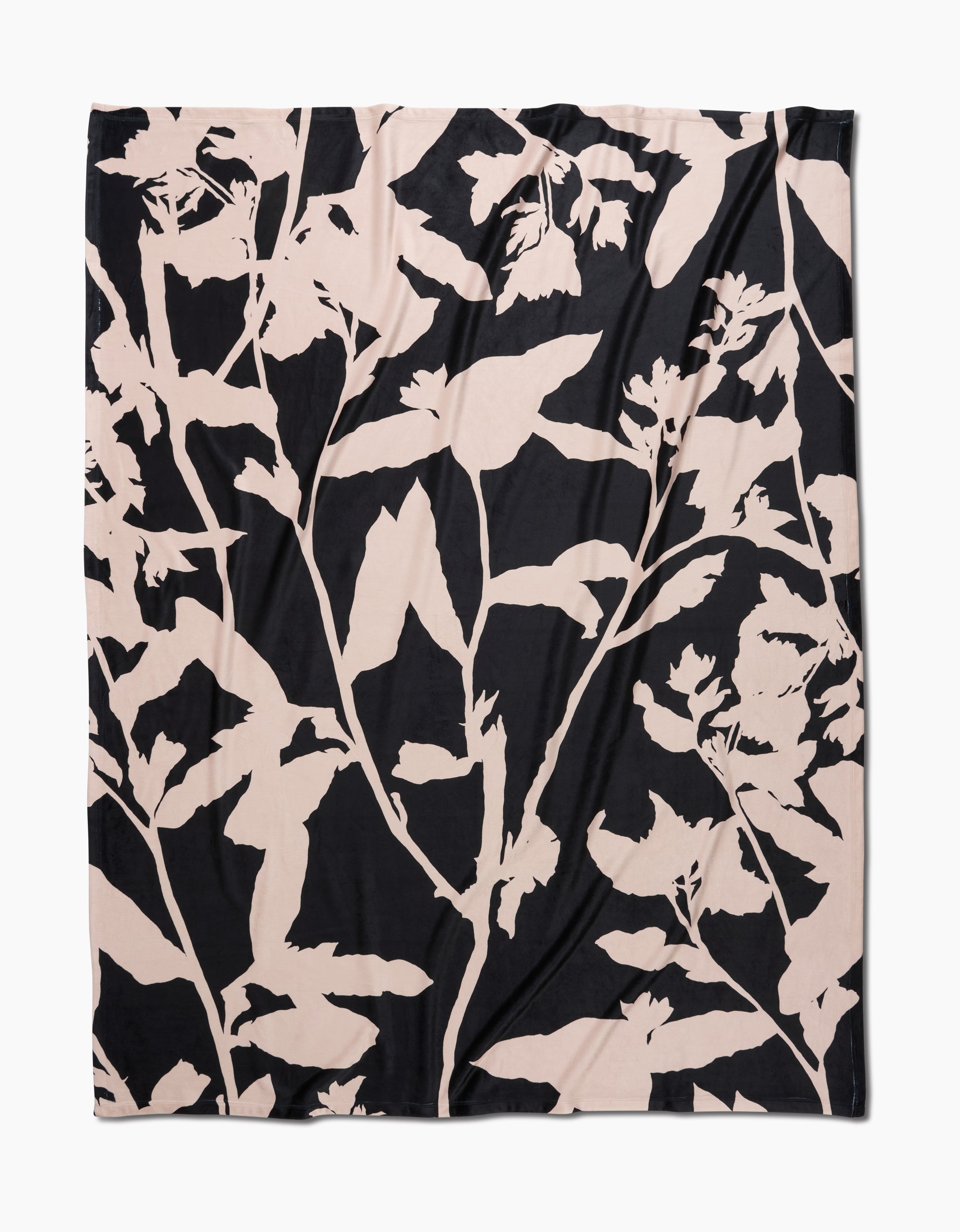 Pam by Geometry is a square fabric made from recycled materials, featuring a bold abstract botanical pattern with large pale beige plant silhouettes on a solid black background for a modern, striking look.