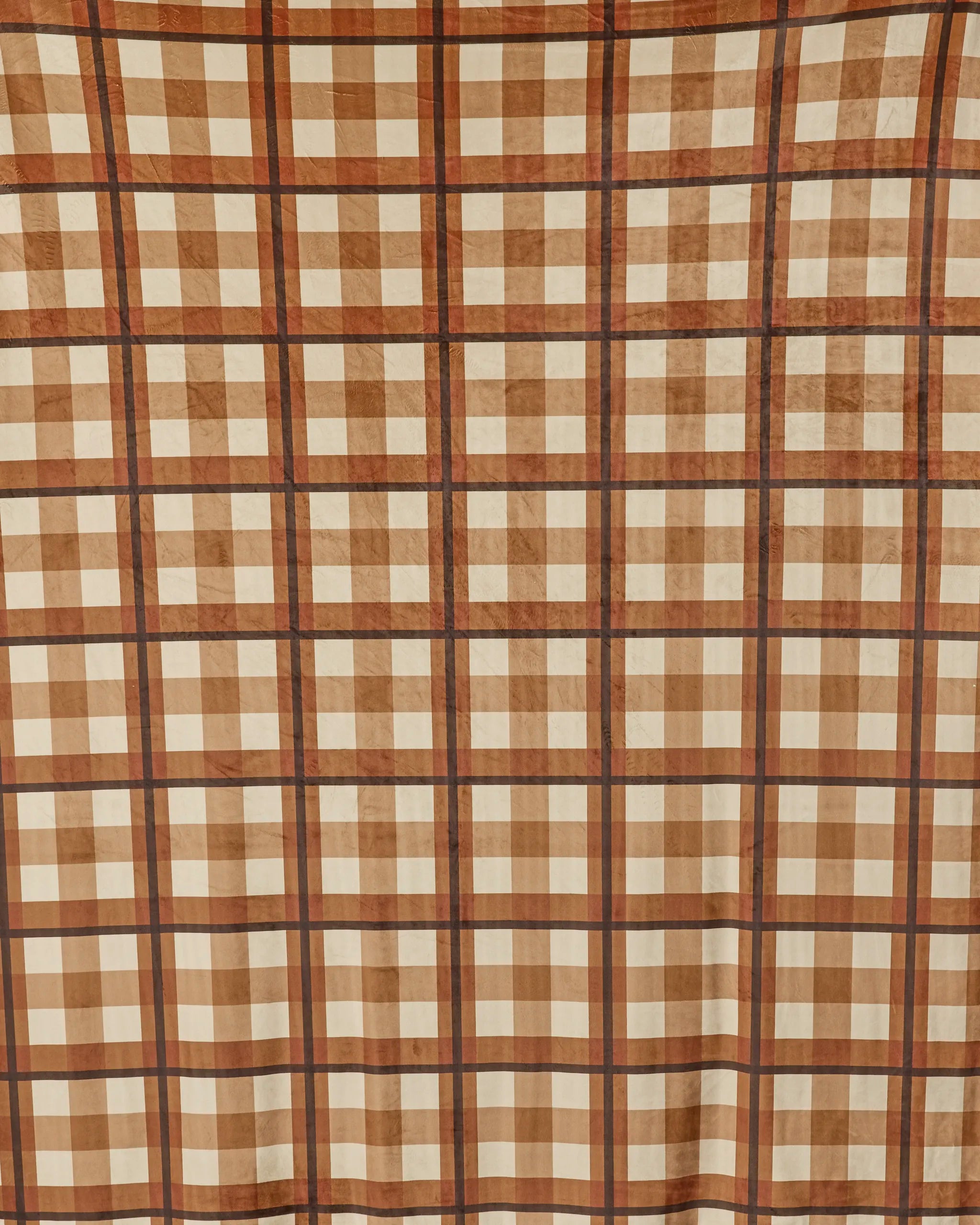 The Geometry Rich Cocoa throw blanket features a soft, plaid design in brown, beige, and cream with intersecting lines forming squares—perfect for cozy moments and crafted sustainably like premium recycled blankets.