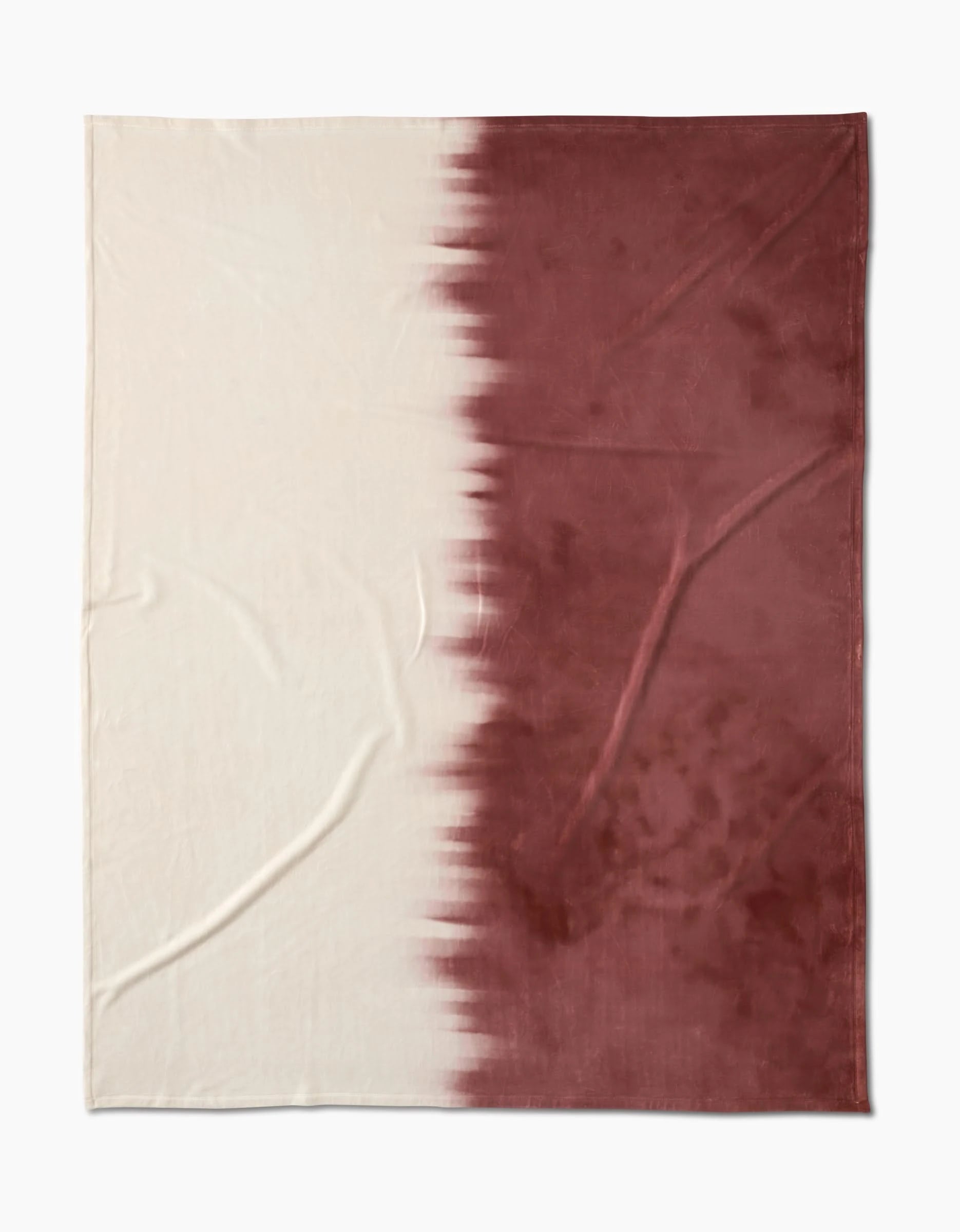 The Geometry Sundae is a rectangular Butter Blanket featuring a two-tone design: solid cream on the left, deep maroon on the right, divided by a jagged, blurred vertical line. Crafted from recycled materials for eco-friendly appeal.