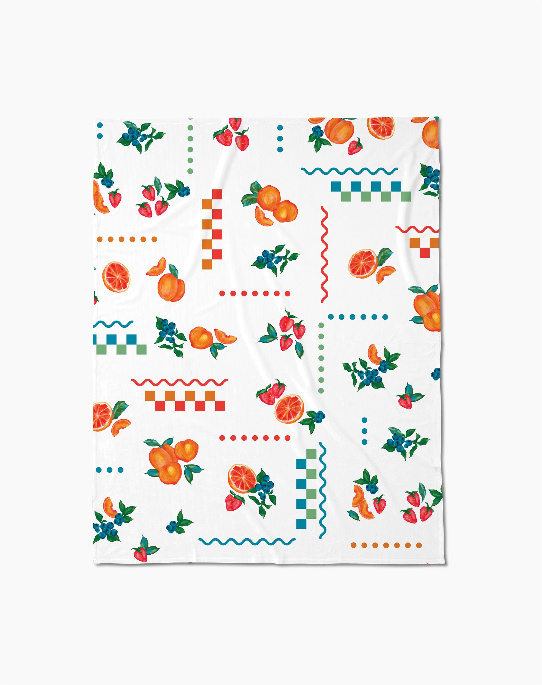 The Aubrey Fairchild Sweet Pickings Butter Blanket offers silky softness with a vibrant design of oranges, strawberries, leaves, and colorful geometric shapes in red, blue, and green.