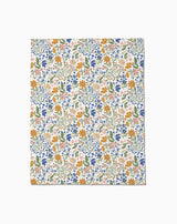 Wildflower Vine Blush by Danelys Sidron: a flat sheet of paper with a colorful floral pattern—orange, blue, and pink flowers with green leaves on white—densely arranged and inspired by the silky softness of Butter Blankets.