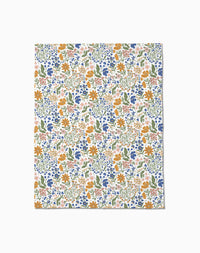 Wildflower Vine Blush by Danelys Sidron: a flat sheet of paper with a colorful floral pattern—orange, blue, and pink flowers with green leaves on white—densely arranged and inspired by the silky softness of Butter Blankets.
