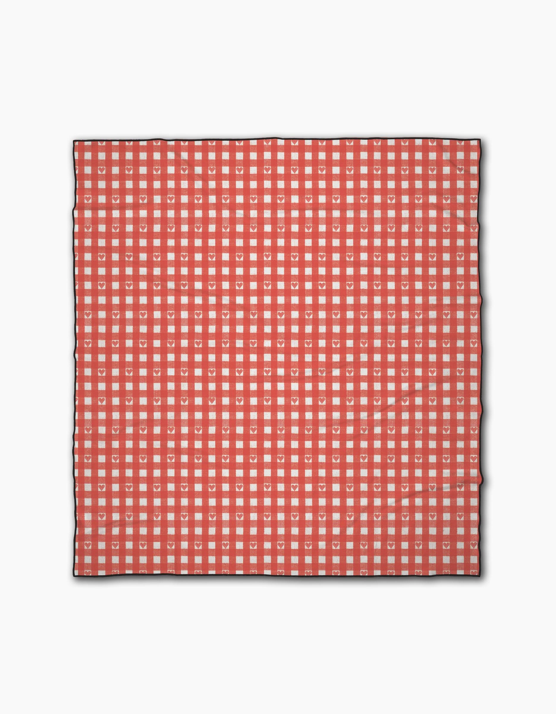 The Geometry Amorcito Gingham beach blanket features a red and white checkered grid with small hearts in each white square. Made from quick-drying recycled material, it’s outlined in black on a plain white background.