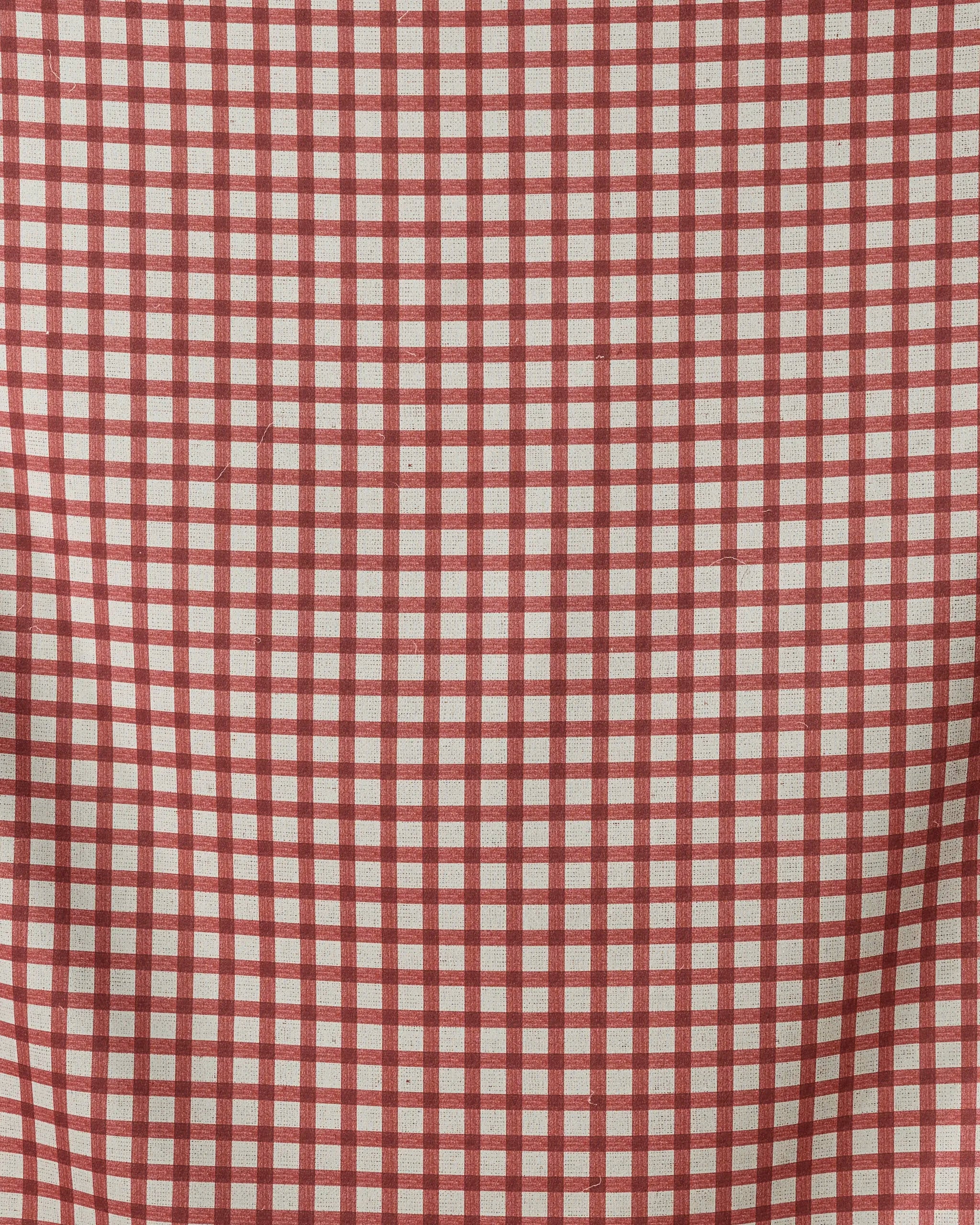 The Apple Picnic beach blanket by Geometry features a red and white checkered grid on a white background, made from quick-drying, recycled materials with a subtly textured finish and gentle folds.