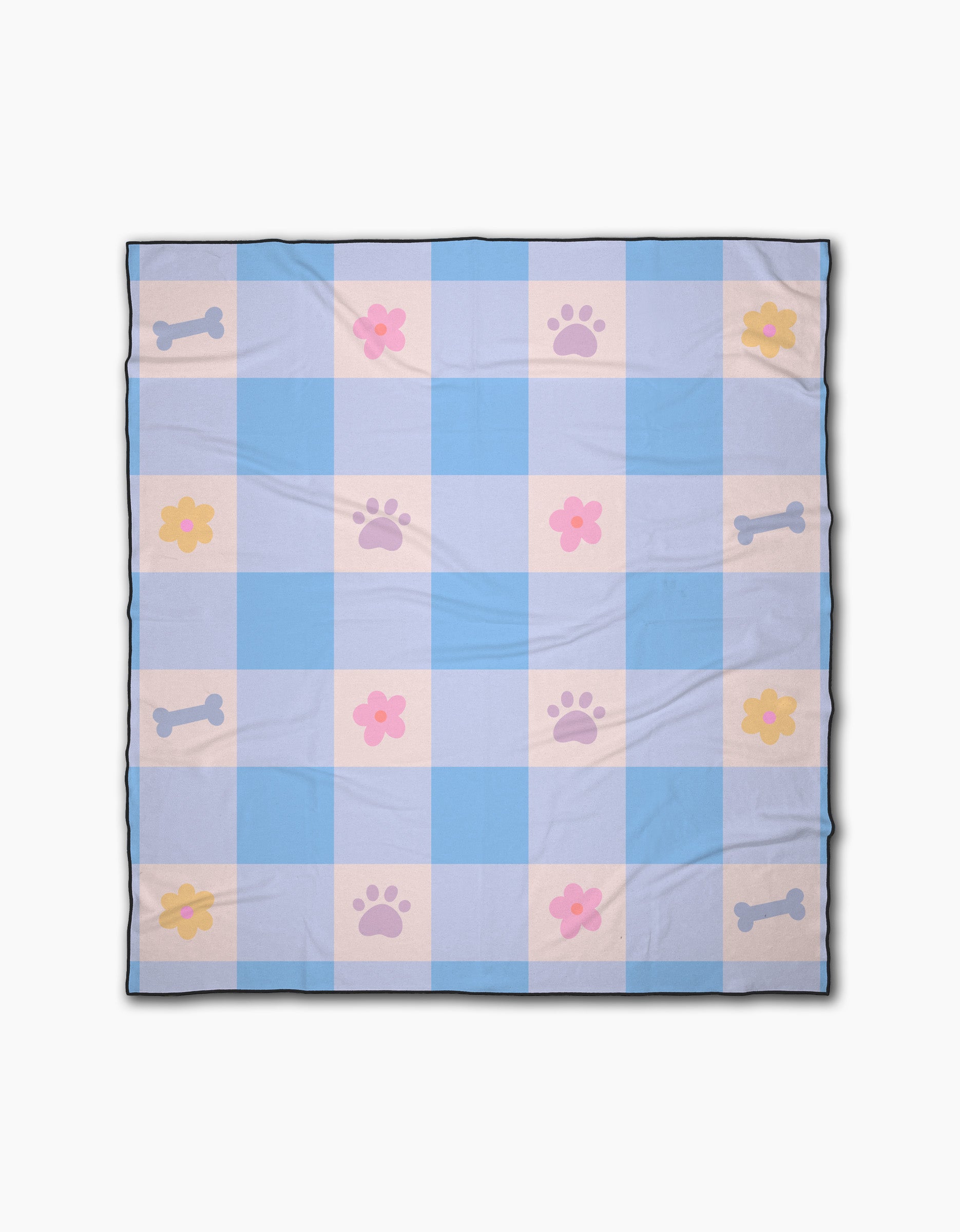 The Blue Sky Picnic Dreams blanket by Letters By Shells is a light blue and white checkered beach blanket with pink paw prints, yellow and pink flowers, and blue bones in a repeating pattern.