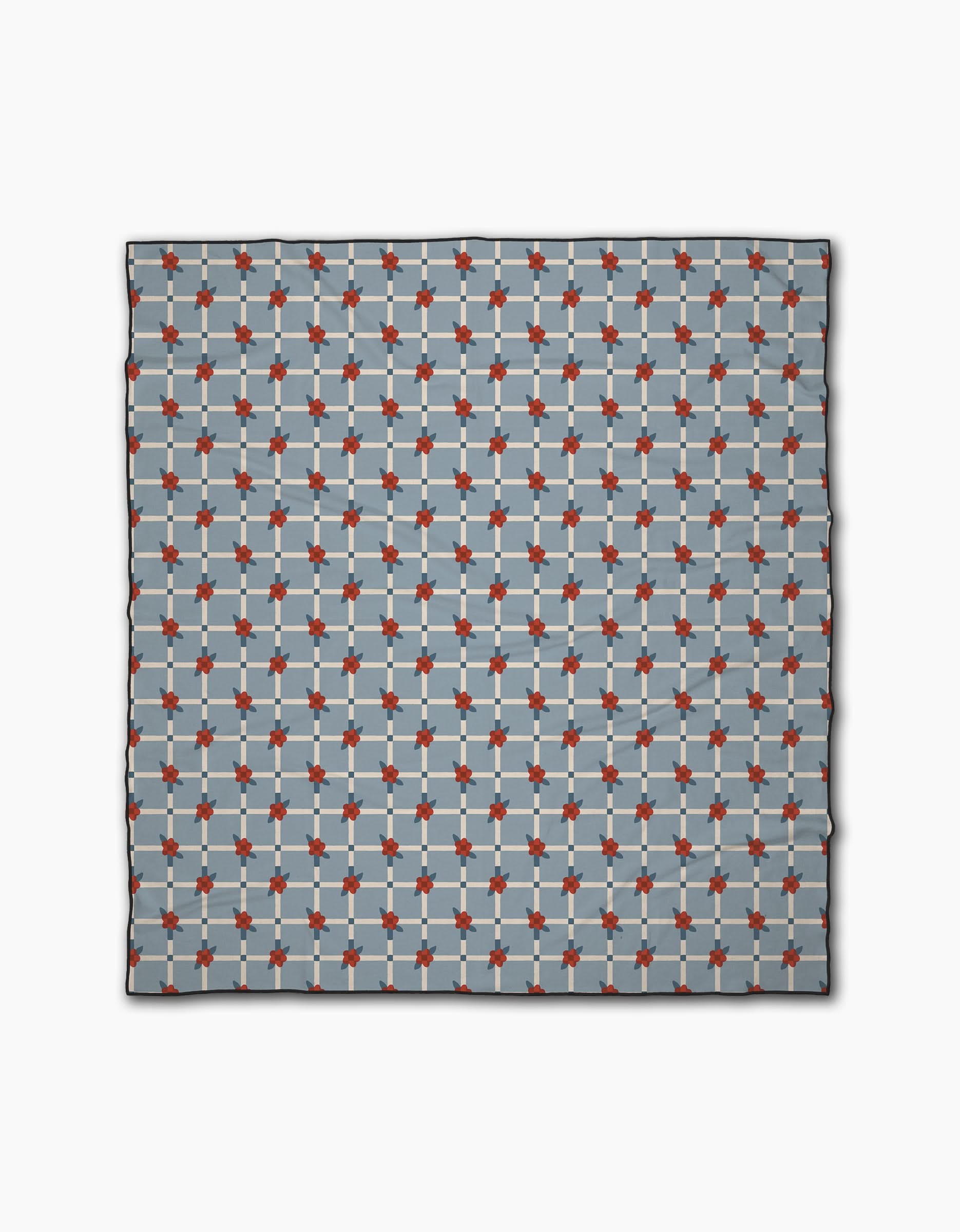 The Floral Parade Grid scarf by Geometry is a square accessory made from recycled materials, showcasing a repeating red, light blue, and dark blue geometric pattern on a light gray grid background.