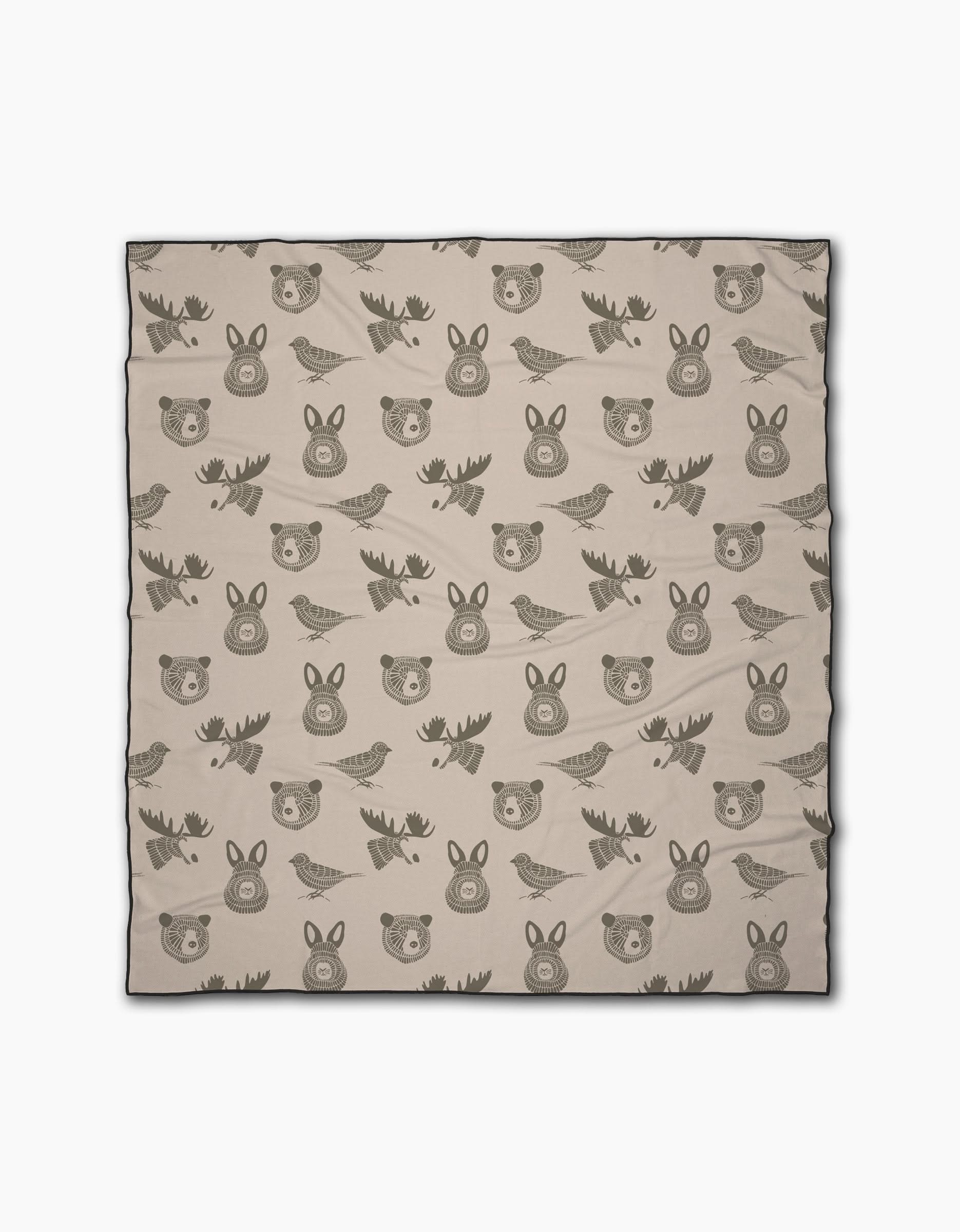 Forest Animals by Rosa Kichline is a beige recycled beach blanket with cute cartoon-style faces of bears, moose, rabbits, and birds in dark brown outlines—perfect for outdoor adventures and eco-conscious comfort.