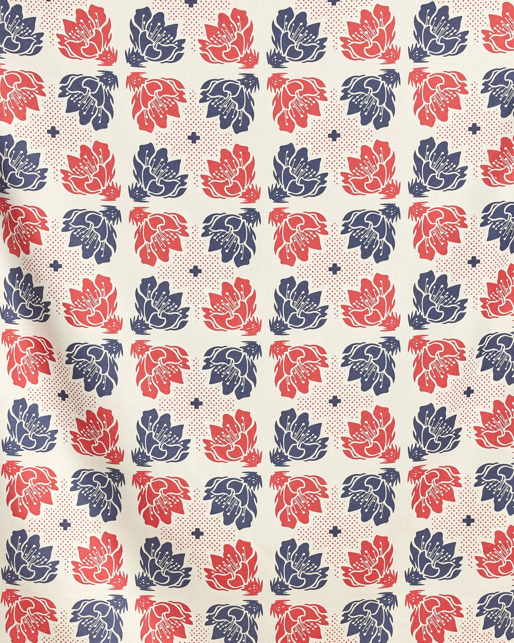 Founding Floral by Geometry features a grid of stylized blue and red flowers with dots and star shapes on cream—ideal for a quick-drying beach blanket made from recycled materials.