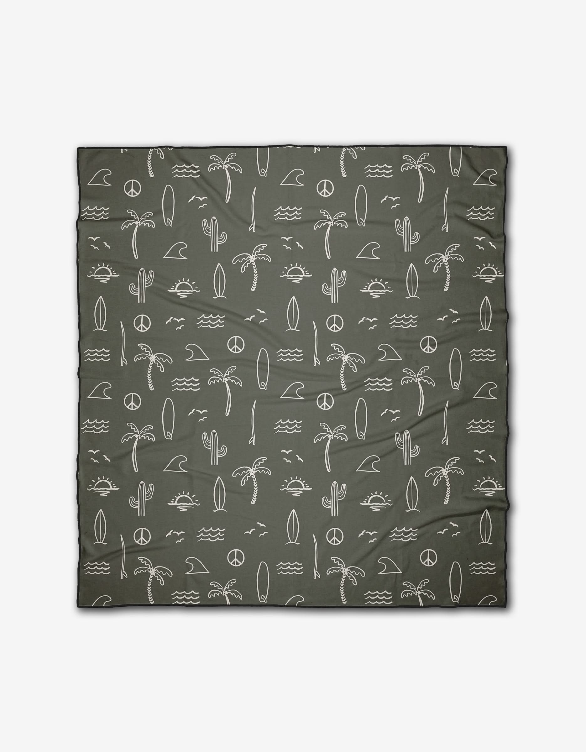 The Hufton Studio Green Summer Vibes beach blanket features white minimalist palm trees, cacti, waves, surfboards, suns, moons, and peace signs on recycled material. Quick-drying and ideal for any adventure.