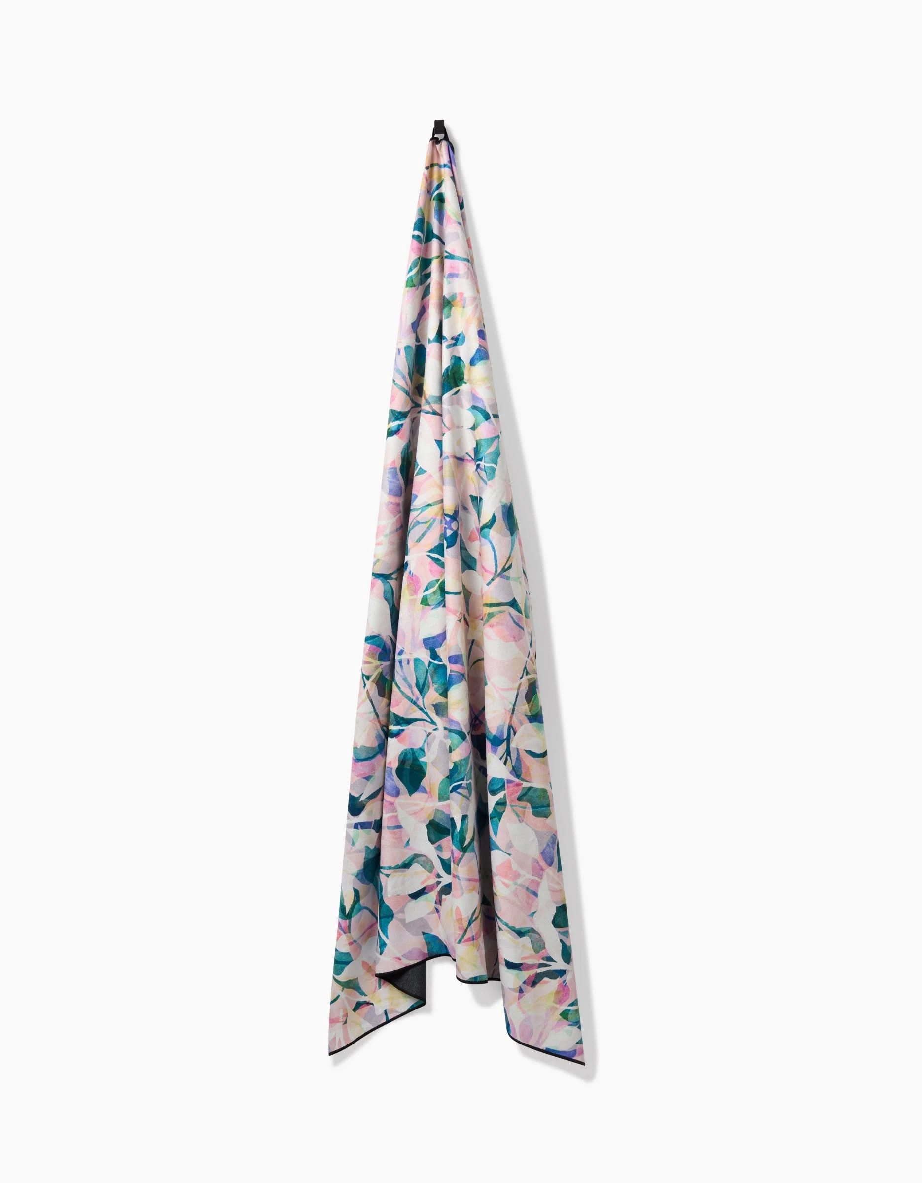The Painted Foliage fabric by Rachel Parker, made from recycled materials and featuring a pastel floral pattern, hangs vertically from a hook against a plain white background.