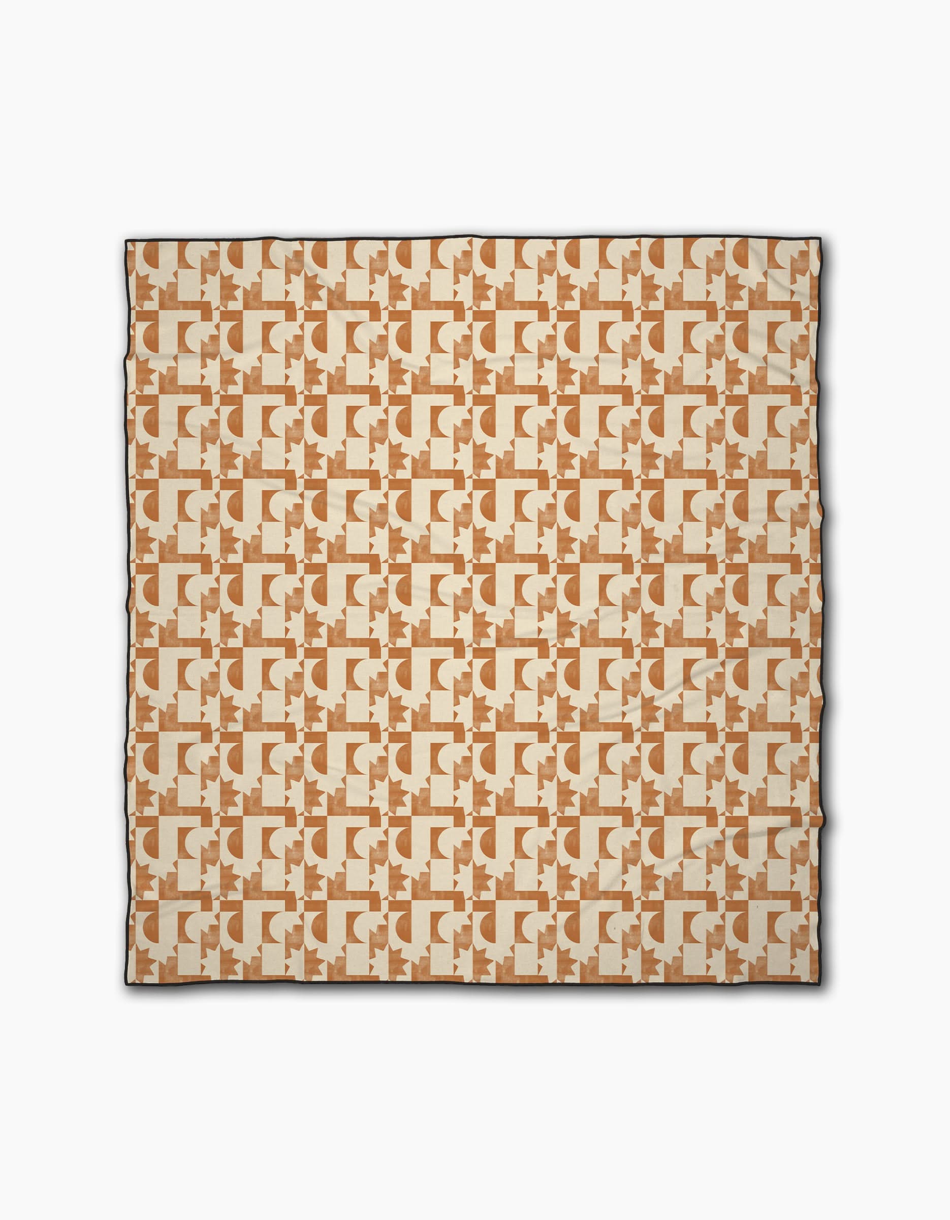 The Solar Power beach blanket by Geometry is a square design featuring interlocking abstract shapes in beige and brown on a cream background, made from quick-drying recycled materials with a slim dark border.