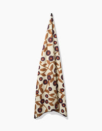 The Swirling Vines beach blanket by Lizzie Clark features a quick-drying fabric with a cream background and a bold, abstract floral pattern in brown, tan, and dark red.