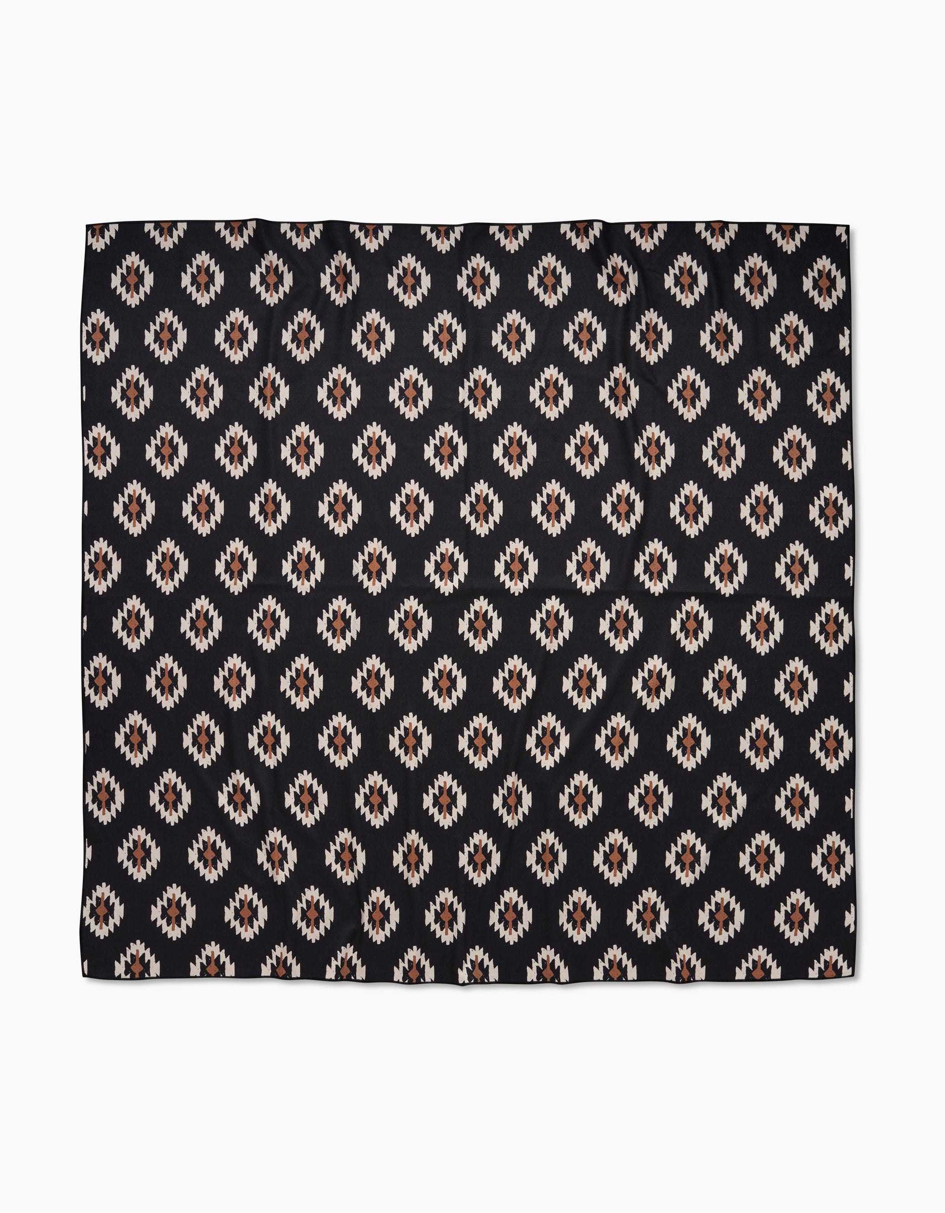 The Hufton Studio Western Tile Beach Blanket showcases a repeating geometric pattern with diamond motifs in white, tan, and brown on black, crafted from quick-drying recycled materials.