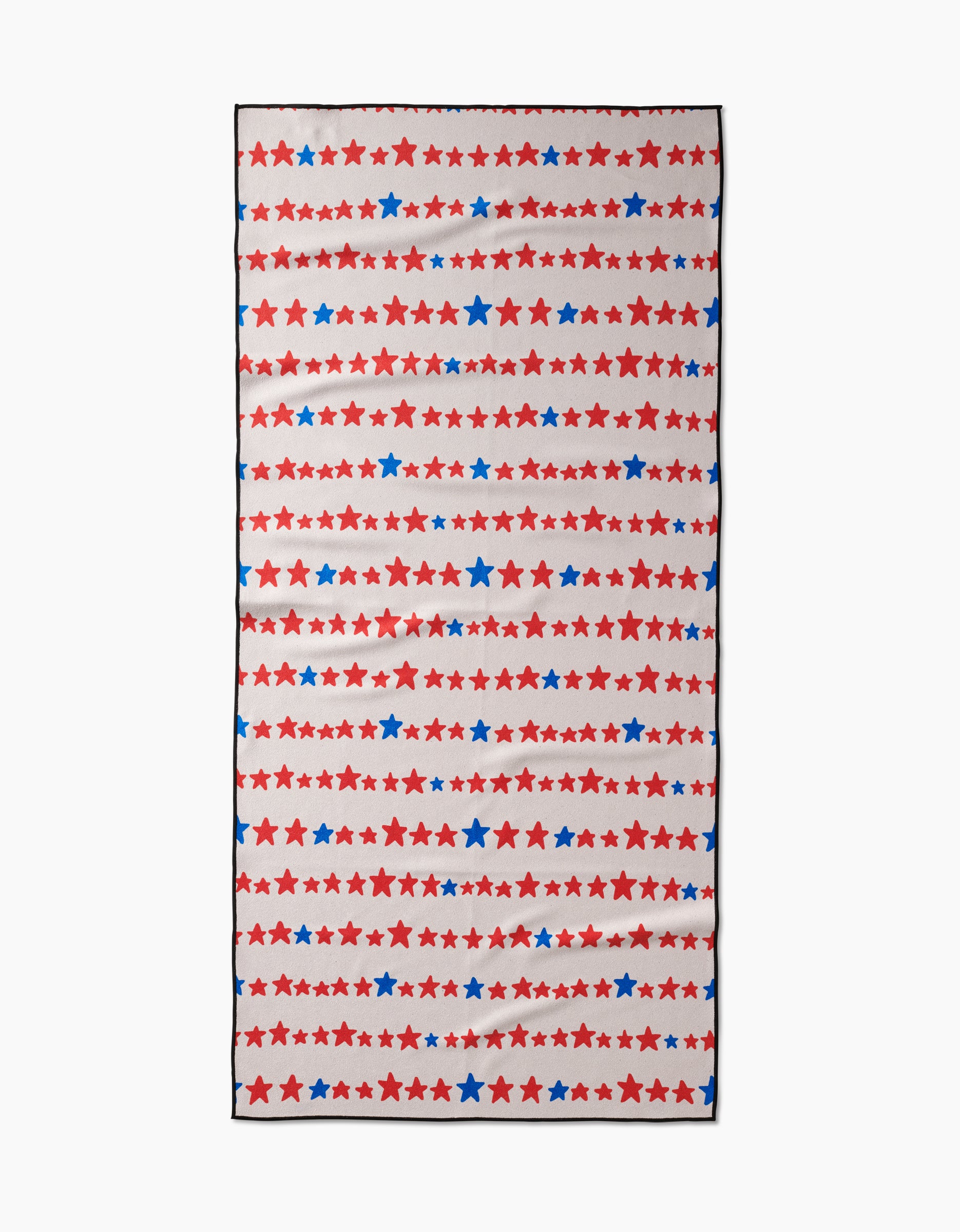 The Kayla Ann Starry Stripes towel features horizontal rows of red and blue stars in various sizes on white. Made from quick-drying, recycled micro-loop material, this rectangular beach towel has a festive, patriotic look.