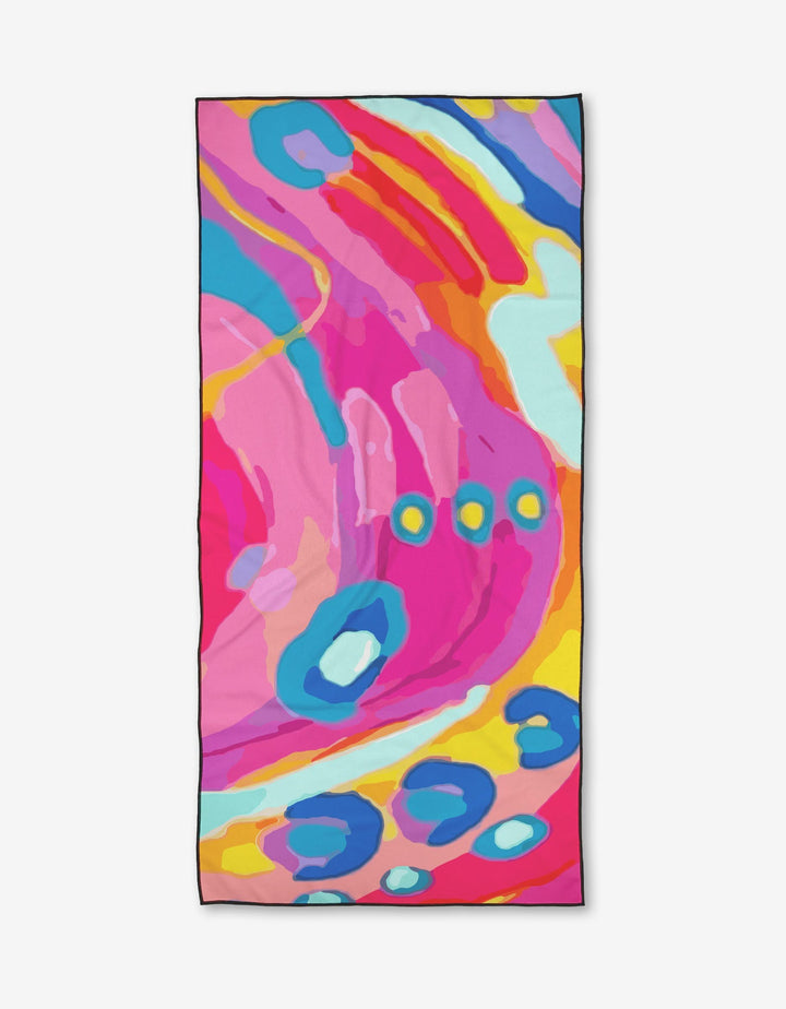 The Sareka Unique Abundance Beach Towel features a dynamic, abstract design in bold colors. Made from quick-drying recycled materials, its modern art-inspired pattern is perfect for a stylish and eco-friendly beach day.