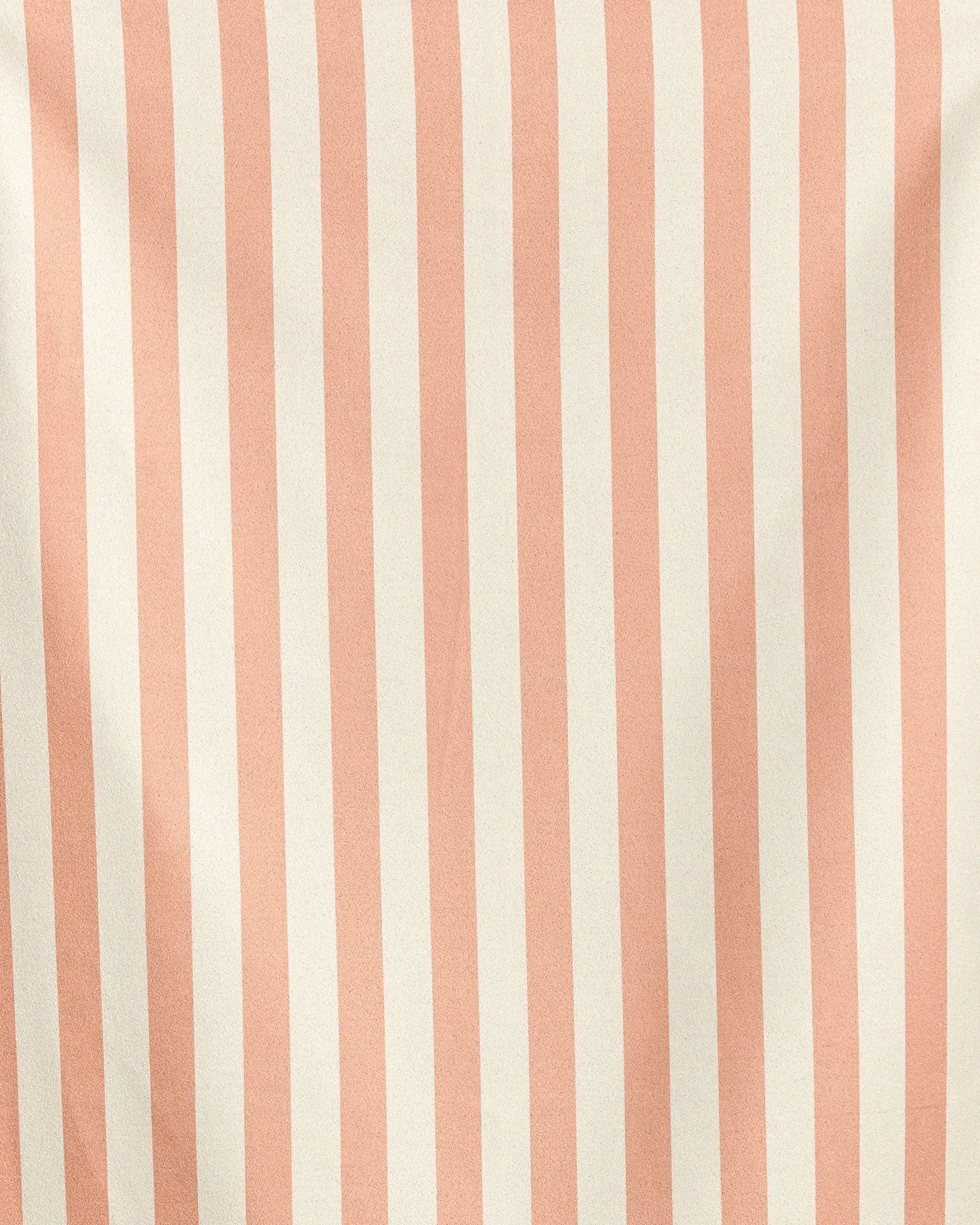 Geometry’s Cabana fabric features vertical, evenly spaced pale pink and off-white stripes. Made from recycled materials, it has a slightly wrinkled texture that creates soft shadows and gentle folds.