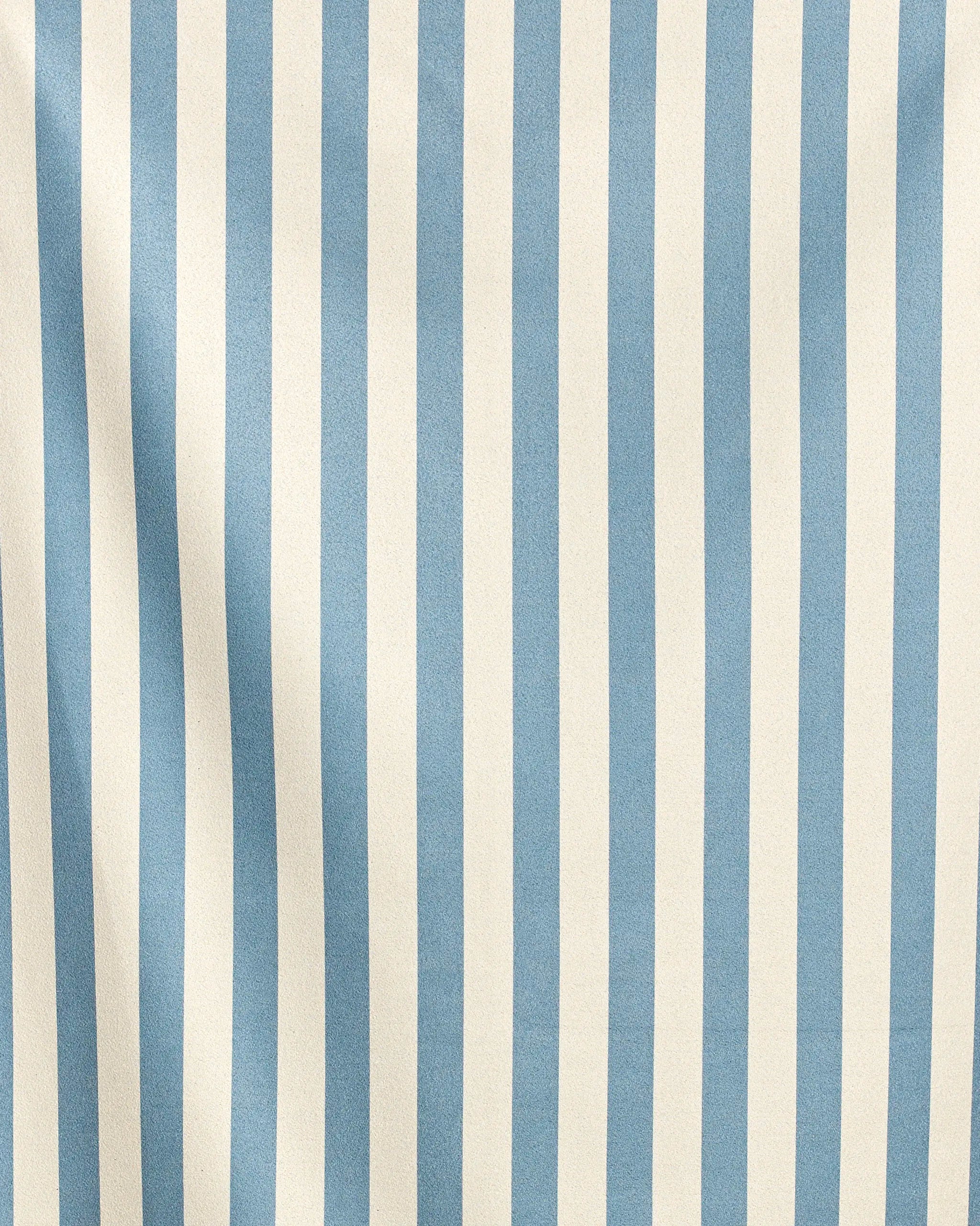 Cabana by Geometry features vertical blue and white stripes on fabric with subtle ripples for gentle shadows and texture, crafted from recycled materials for sustainable style.