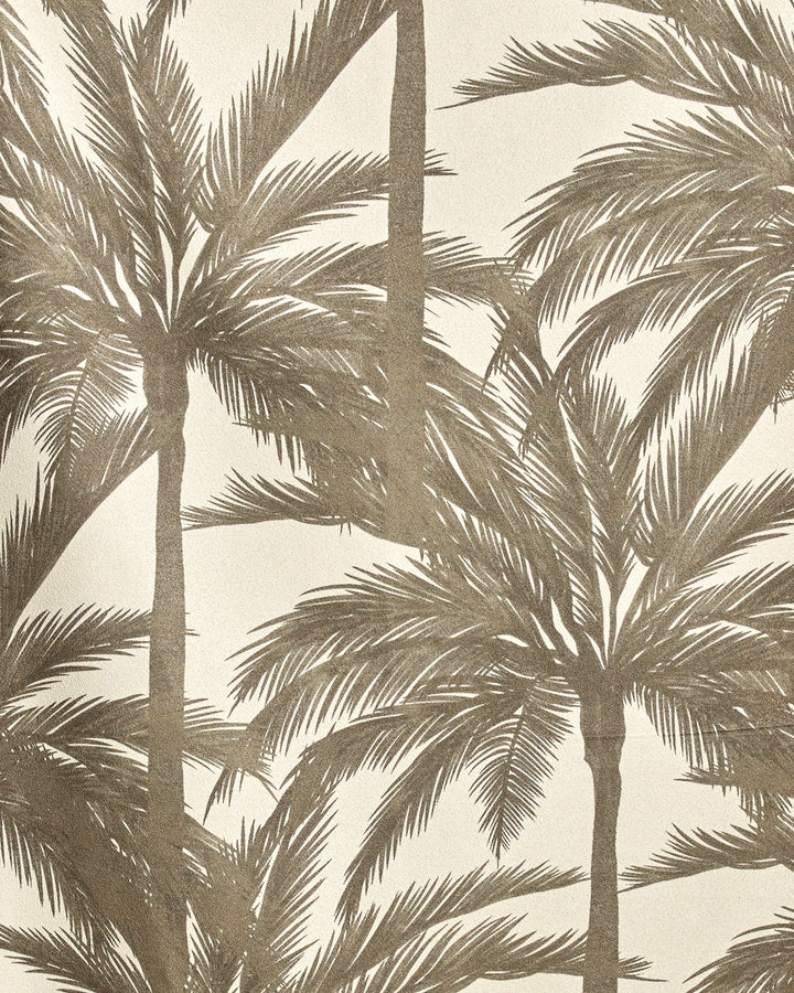 Caligo Brown by Geometry features detailed overlapping palm fronds in brown on a light beige background, creating a tropical, vintage-inspired design ideal for an eco-friendly beach towel.