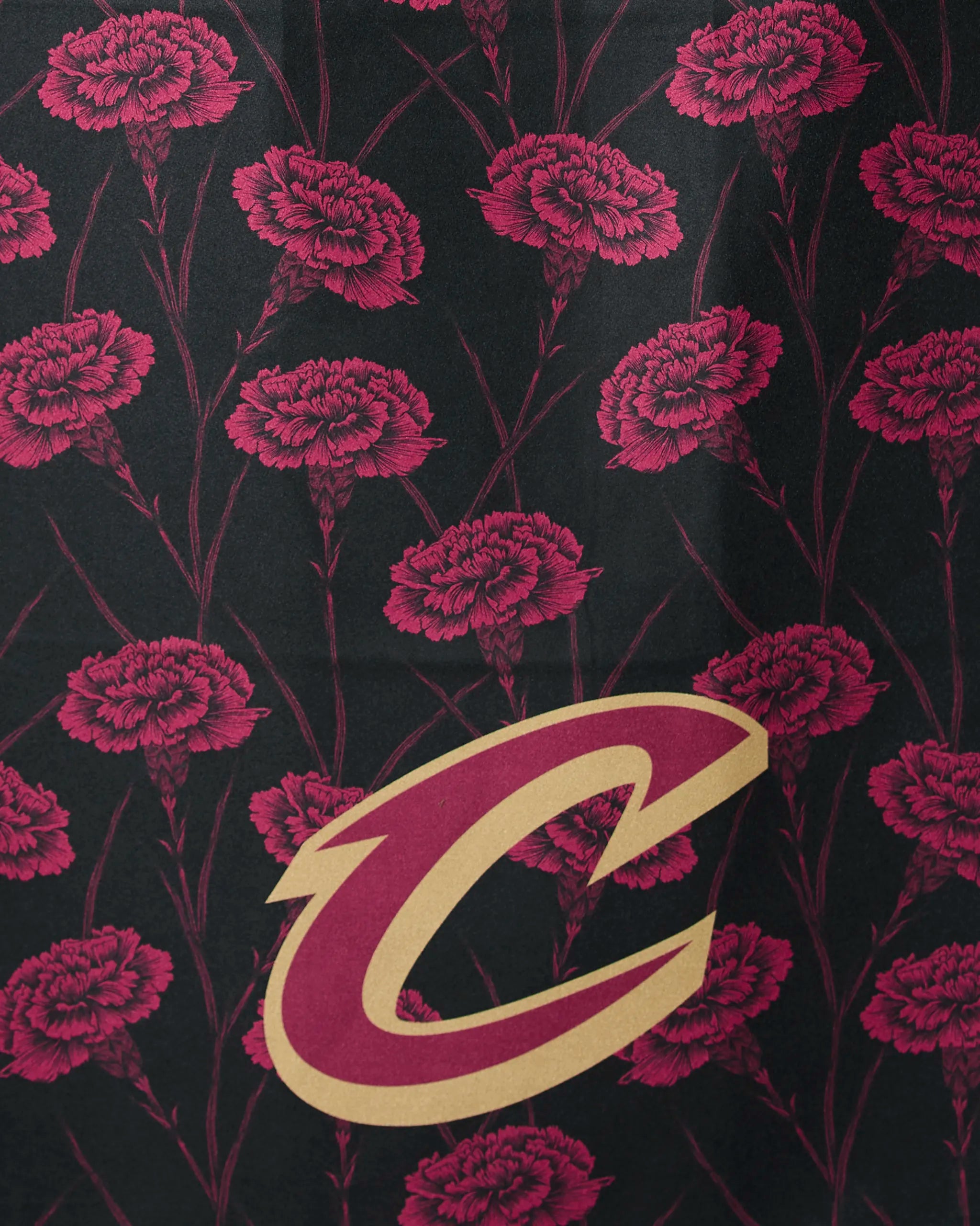 The Cavaliers Floral by Geometry features dark red carnations on black with a large gold and maroon Cleveland Cavaliers “C” logo at the lower center.