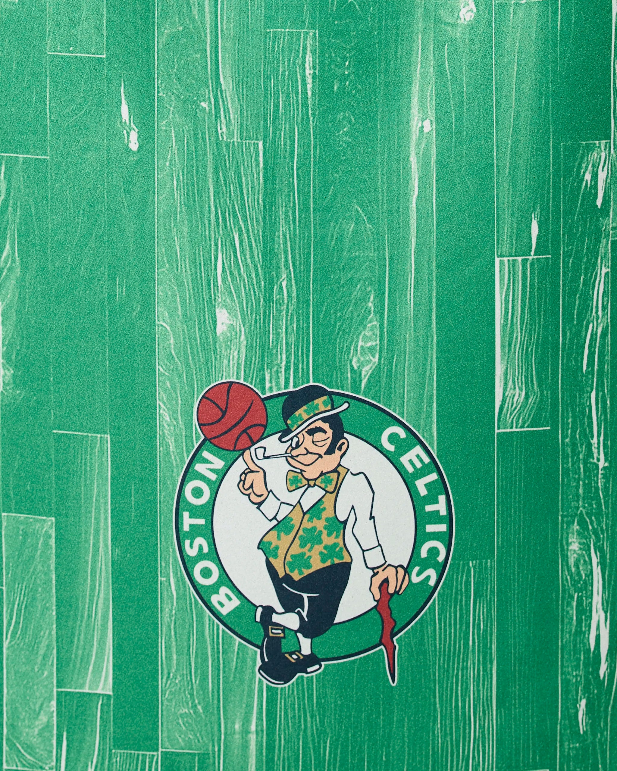 The Celtics Zone mat by Geometry features the Boston Celtics logo with a leprechaun spinning a basketball on a green, wood-patterned background.