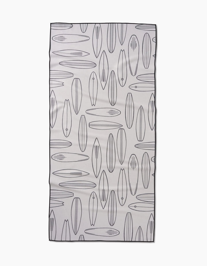 The Cream Summer Surfing beach towel by Hufton Studio quickly dries and showcases a repeating pattern of outlined surfboards in different shapes and sizes on a white background, all edged with a thin black border.