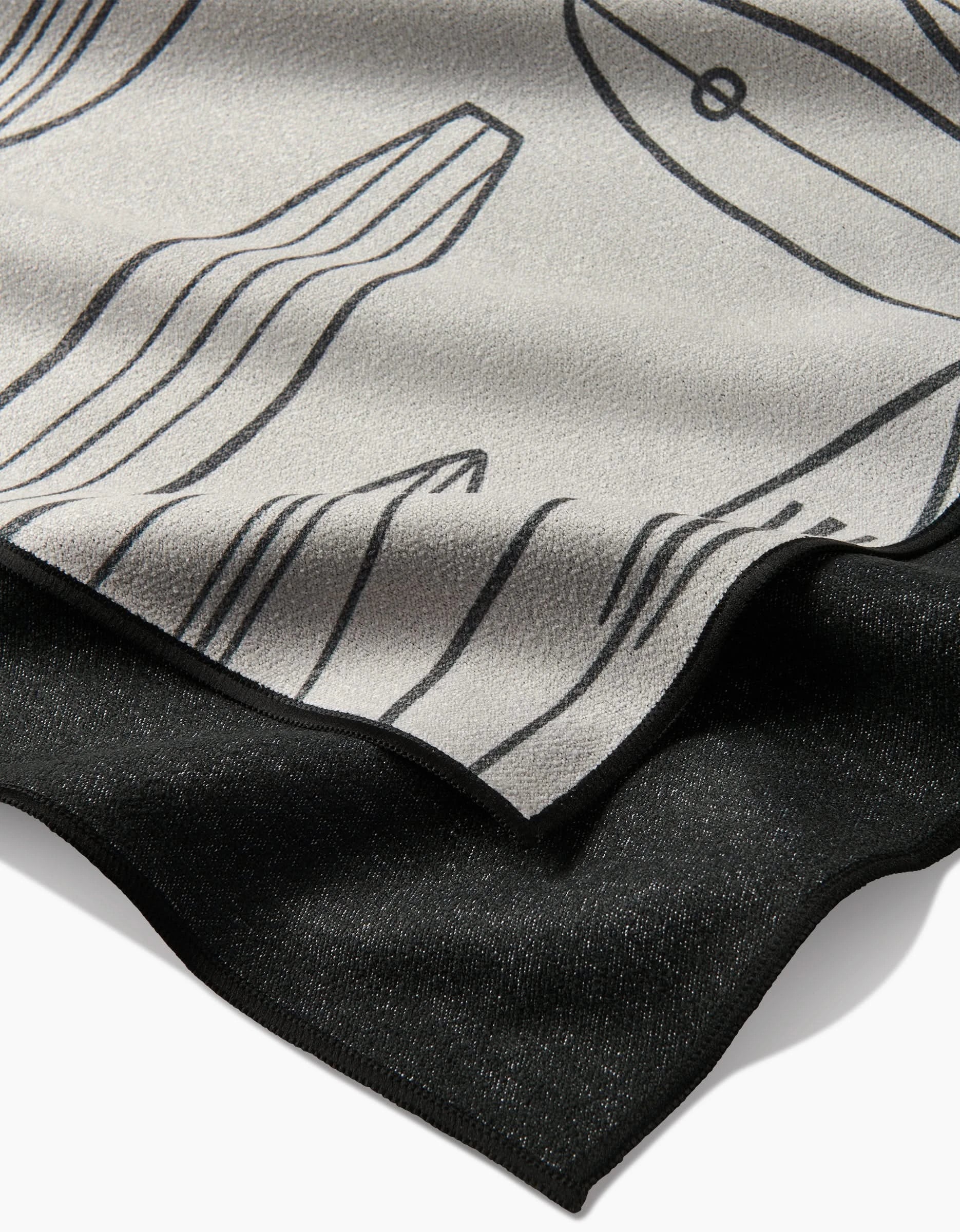 Close-up of Hufton Studios Cream Summer Surfing: overlapping recycled fabrics with the top layer in light gray, black abstract line art, and a solid black bottom. Textures and edges are clearly visible.