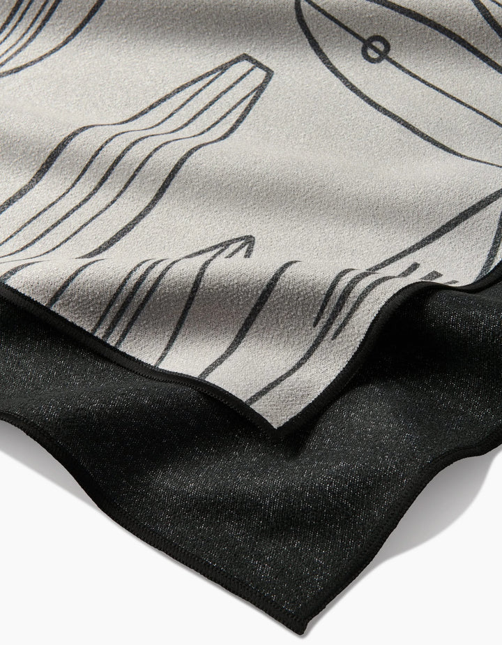 Close-up of Hufton Studios Cream Summer Surfing: overlapping recycled fabrics with the top layer in light gray, black abstract line art, and a solid black bottom. Textures and edges are clearly visible.