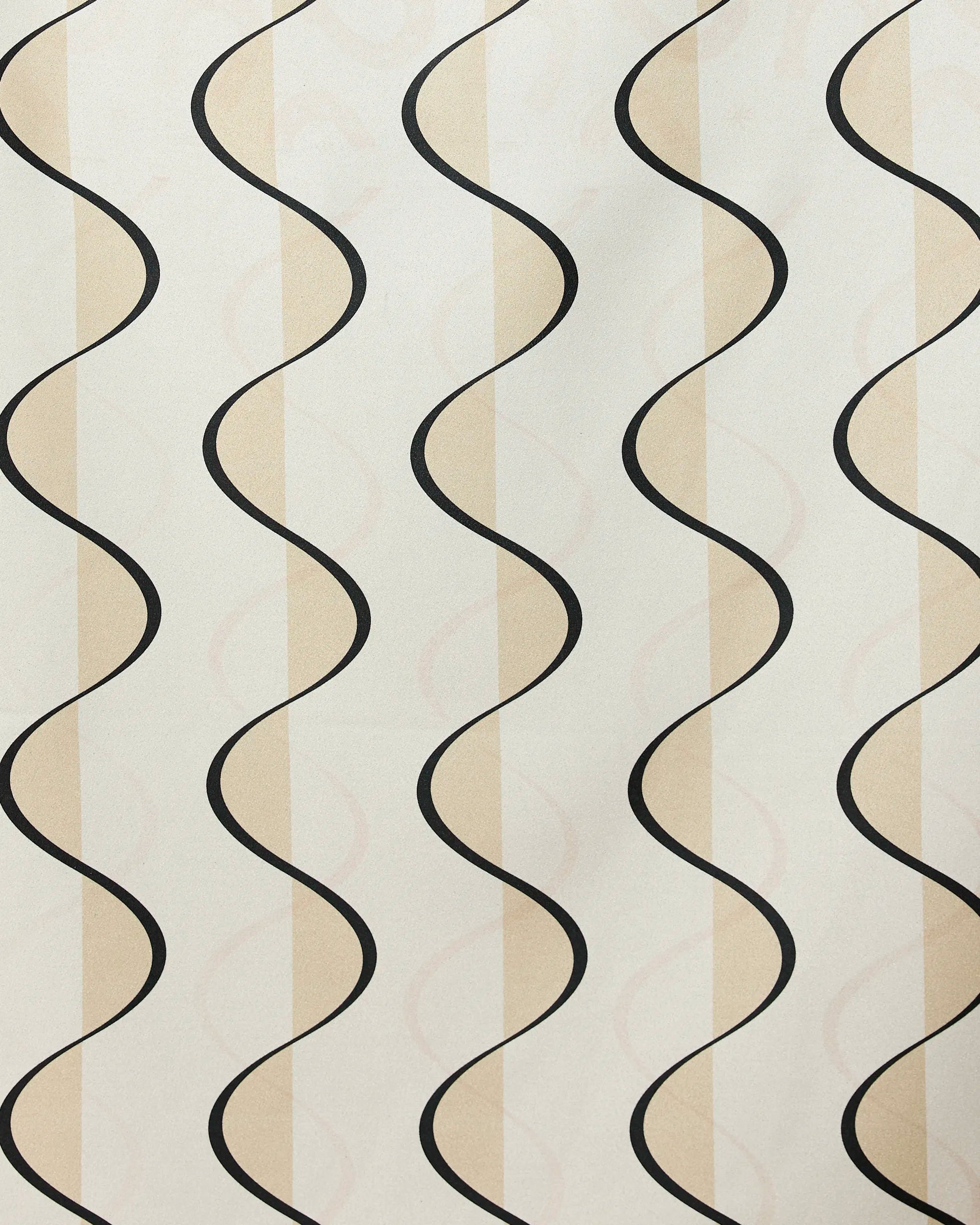 A cream-colored surface with light beige stripes and repeating black wavy lines, this pattern evokes the modern style of Geometry’s Desert Drift beach towel, crafted from recycled materials.