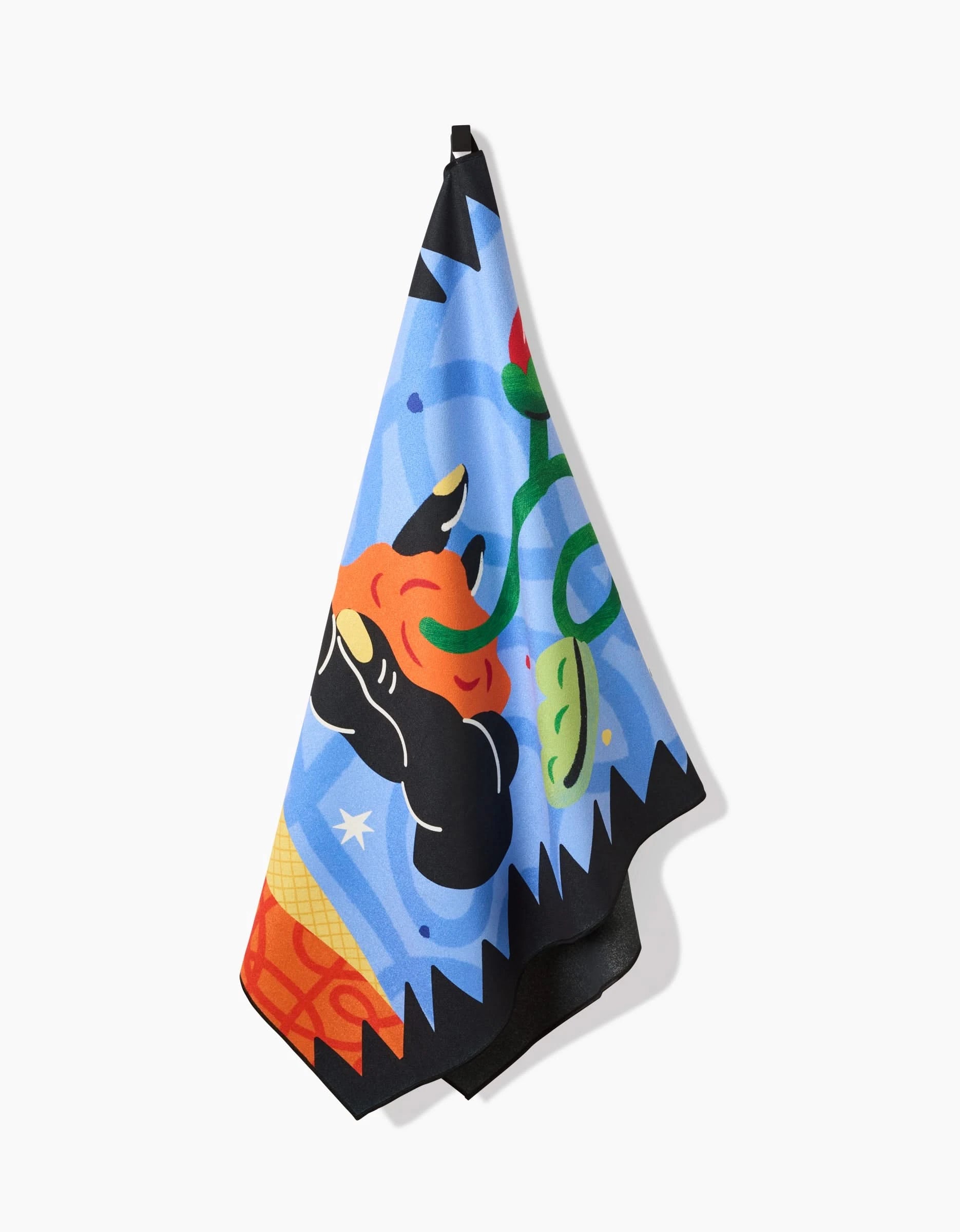 The Earth towel by Camila Leão features bold, cartoonish orange, green, black, and blue shapes on ultra-absorbent fabric. This colorful abstract towel is perfect as a quick-drying beach essential.