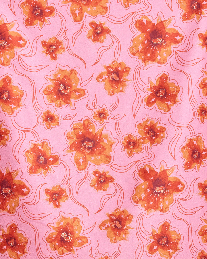 The Geometry Floral Star Burst beach towel features a lively pink fabric with repeating orange and red watercolor-style flowers outlined in red, plus wavy red lines between blooms. Quick-drying for convenient use.