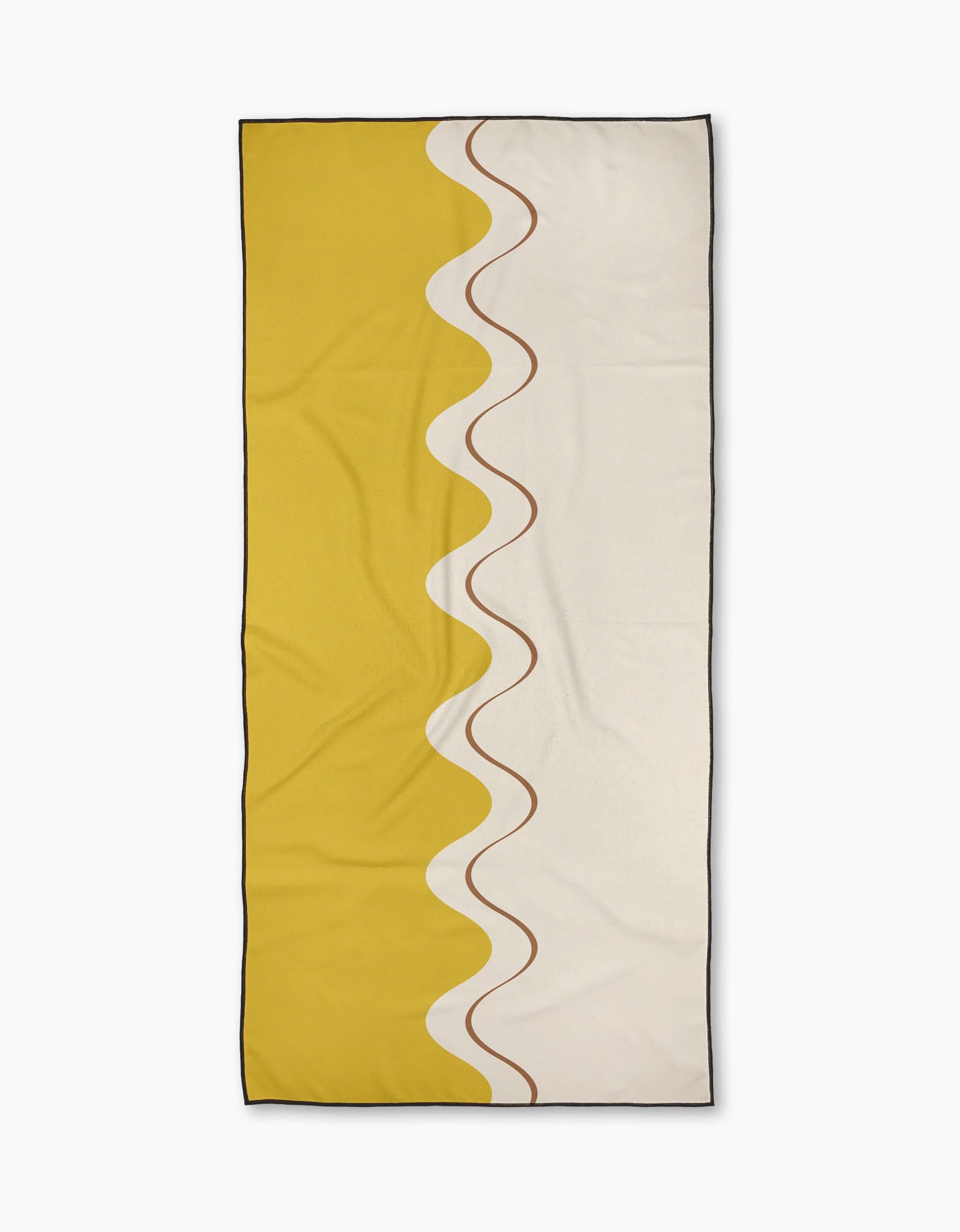 The Golden Tide beach towel by Geometry features quick-drying fabric, a rectangular shape, half solid yellow and half off-white divided vertically by a wavy brown line, and is finished with a slim black border.