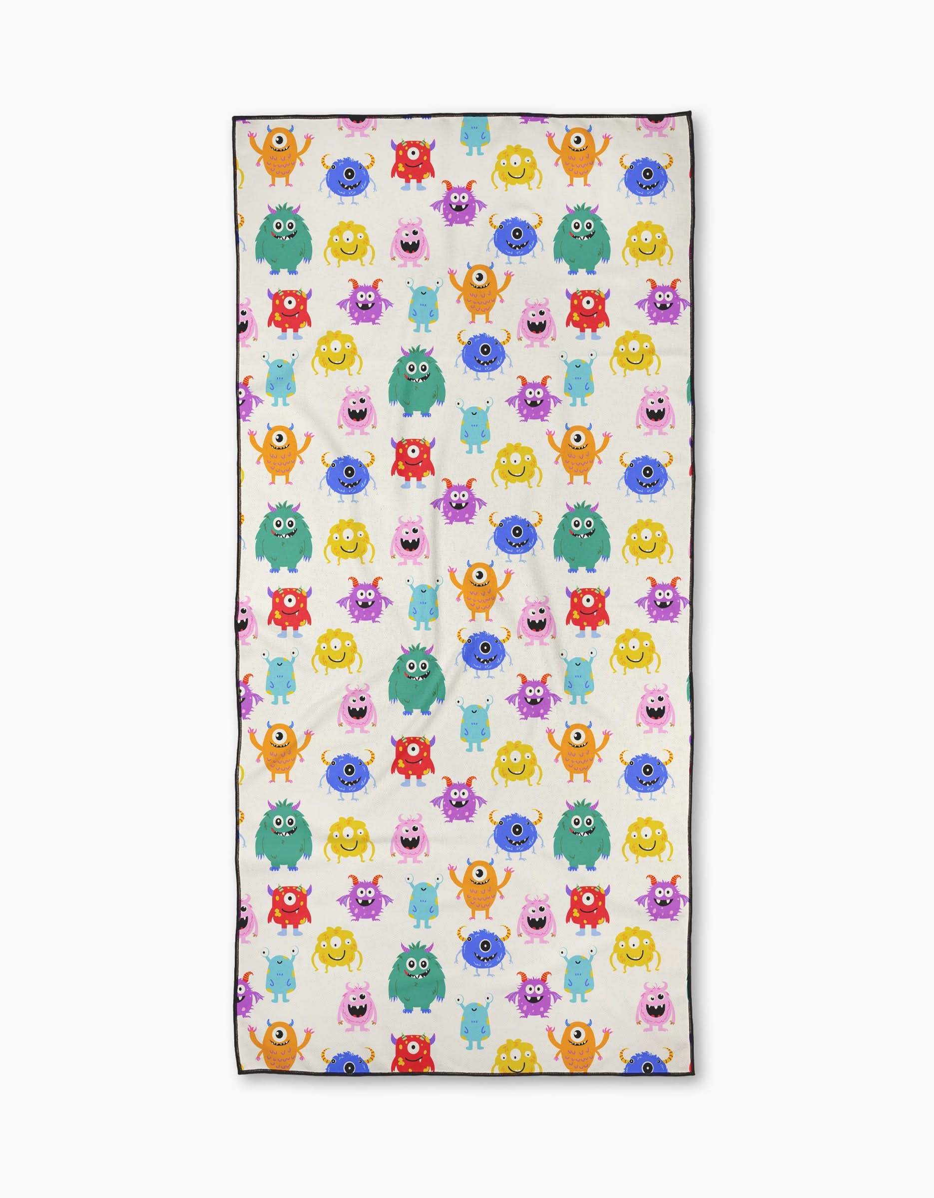 Goofy Critters by Vaishali Design Studio is a rectangular micro-loop beach towel with a playful pattern of colorful cartoon monsters—pink, yellow, green, blue, and orange—of various shapes and expressions on a white background.