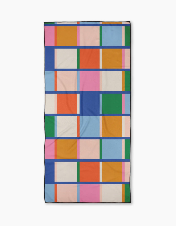 Grid by Jennifer Bouron is a quick-drying Micro-loop Beach Towel with a vibrant geometric grid of colorful rectangles and squares outlined in dark blue—perfect for brightening up your summer days.