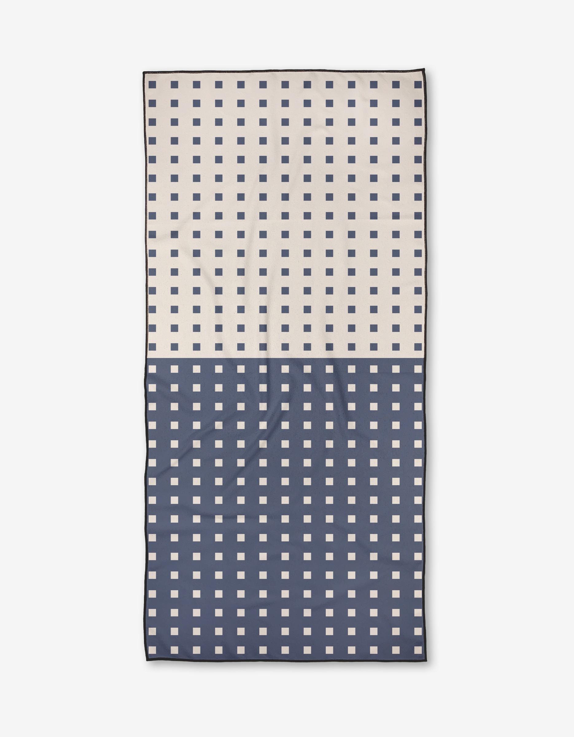 The Harmony Haze by Happy Hemera is a rectangular Micro-loop Beach Towel featuring cream and navy halves with contrasting square grids, crafted from quick-drying recycled materials for sustainable style.