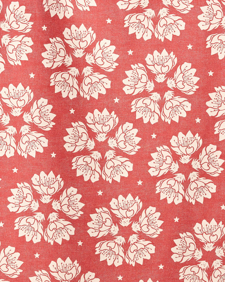 The Geometry Maverick Floral beach towel features a vintage-inspired red design with white floral clusters and small stars on quick-drying micro-loop fabric.