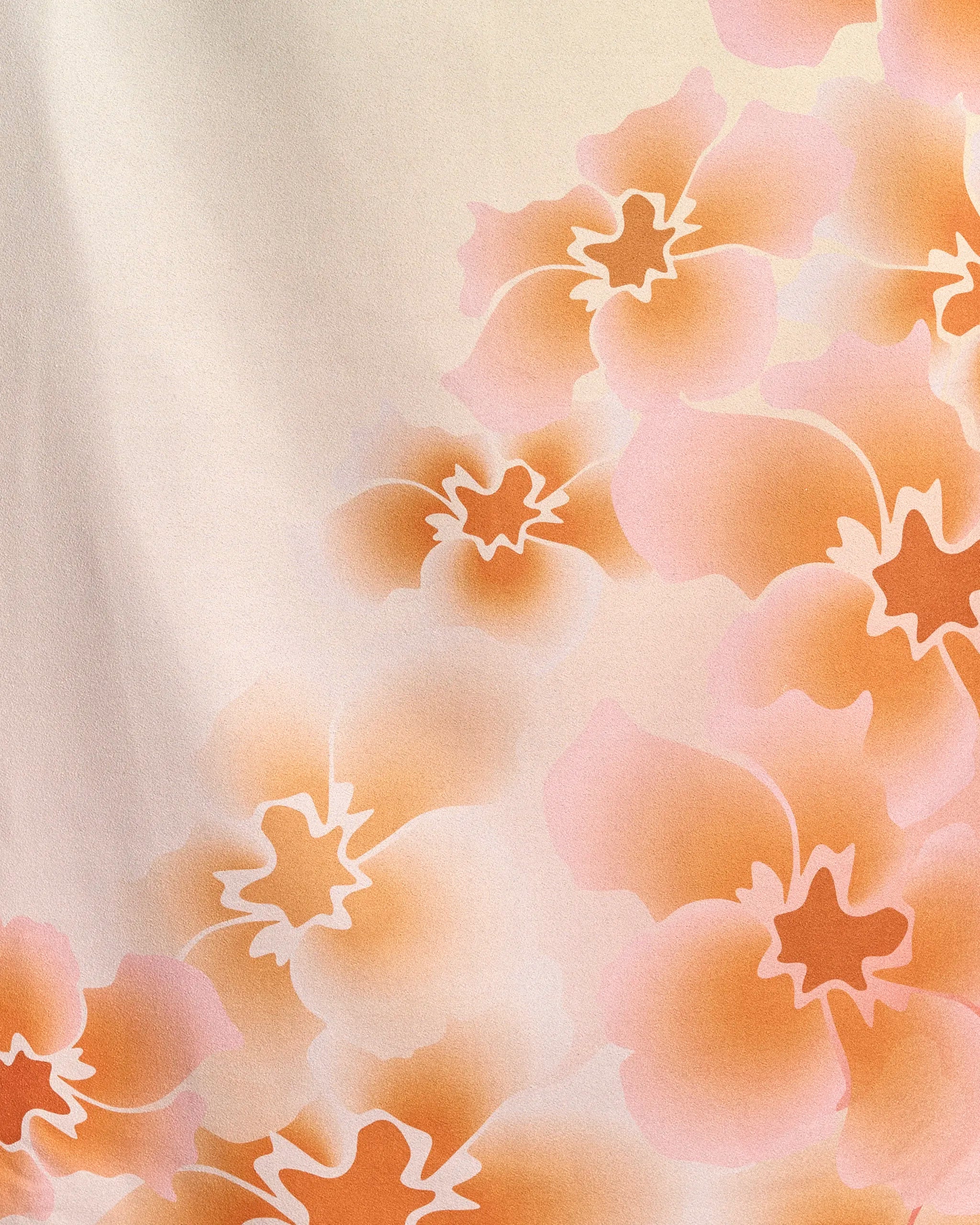Nicole by Geometry features a soft, abstract floral pattern with overlapping peach and orange flowers outlined in white on a light beige background. This gentle, watercolor-inspired design is perfect for a recycled beach towel.