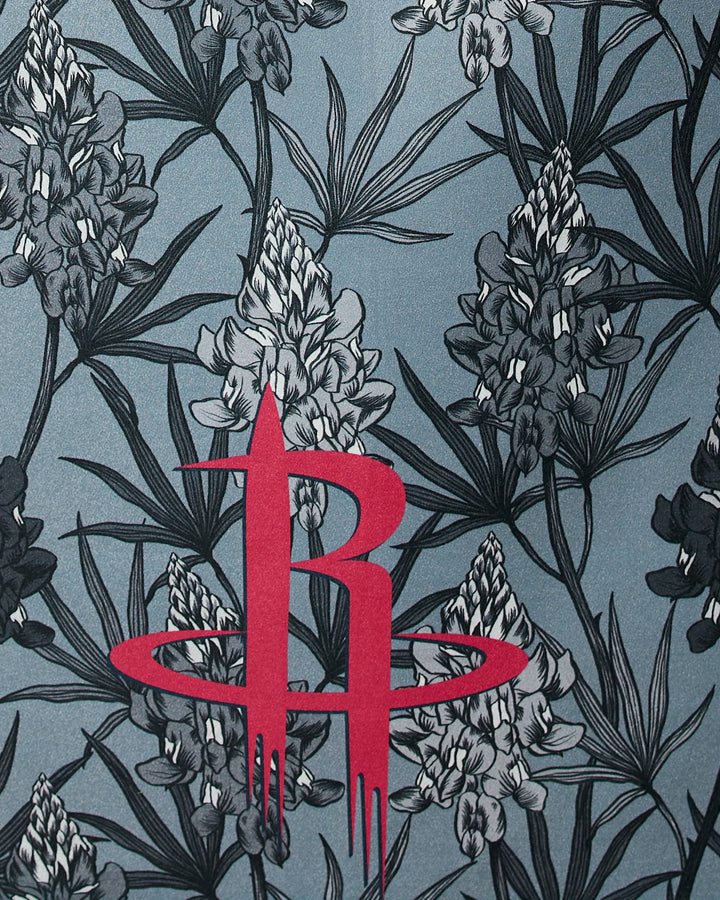 The NBALAB x Geometry Rockets Floral beach towel features gray and black lupine flowers with green leaves and a bold red Houston Rockets logo at the center.