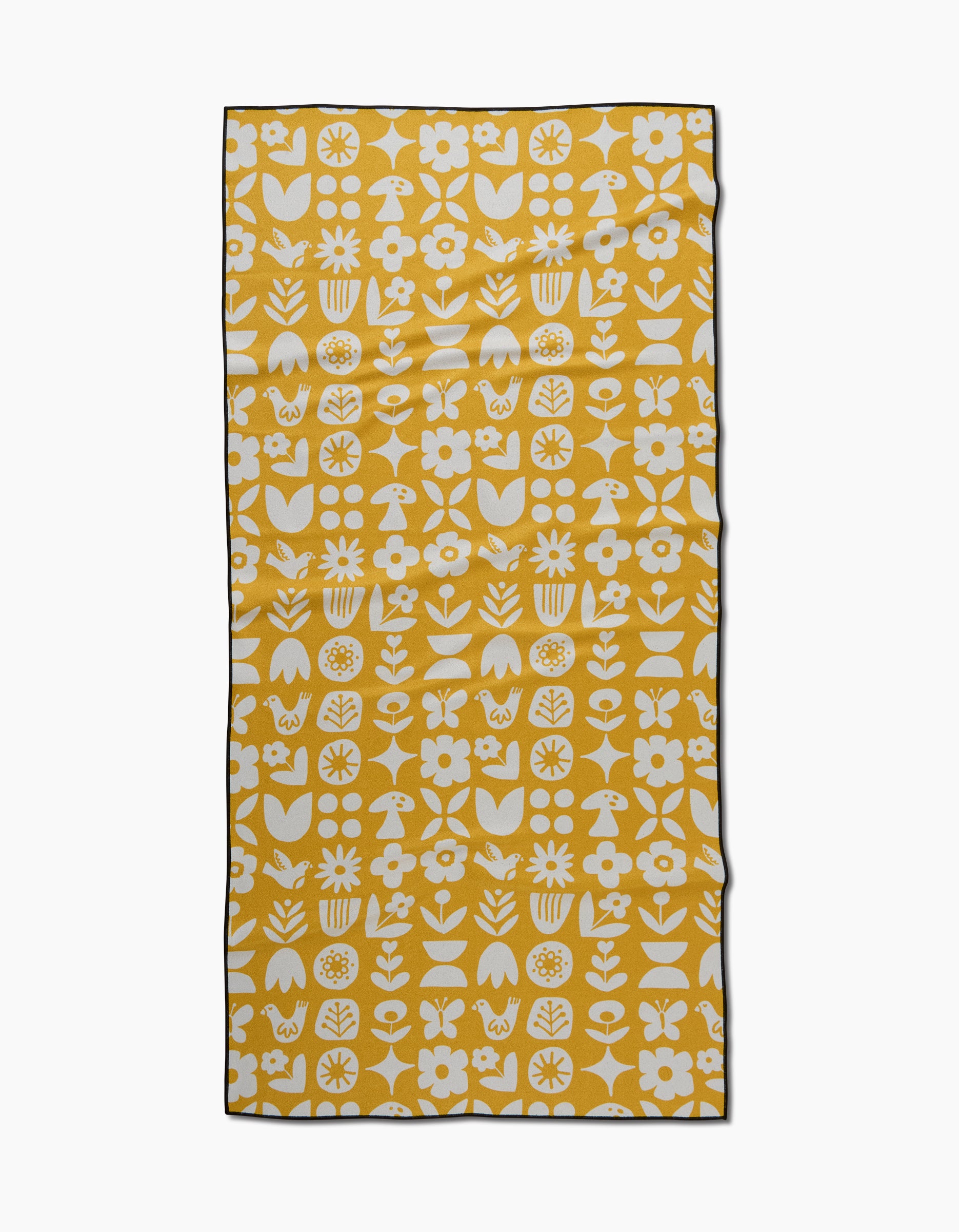The Scandi Spring beach towel by Kayla Ann is yellow and rectangular, with white flowers, leaves, butterflies, mushrooms, and florals in a repeating pattern plus a thin black border—made from quick-drying recycled materials.