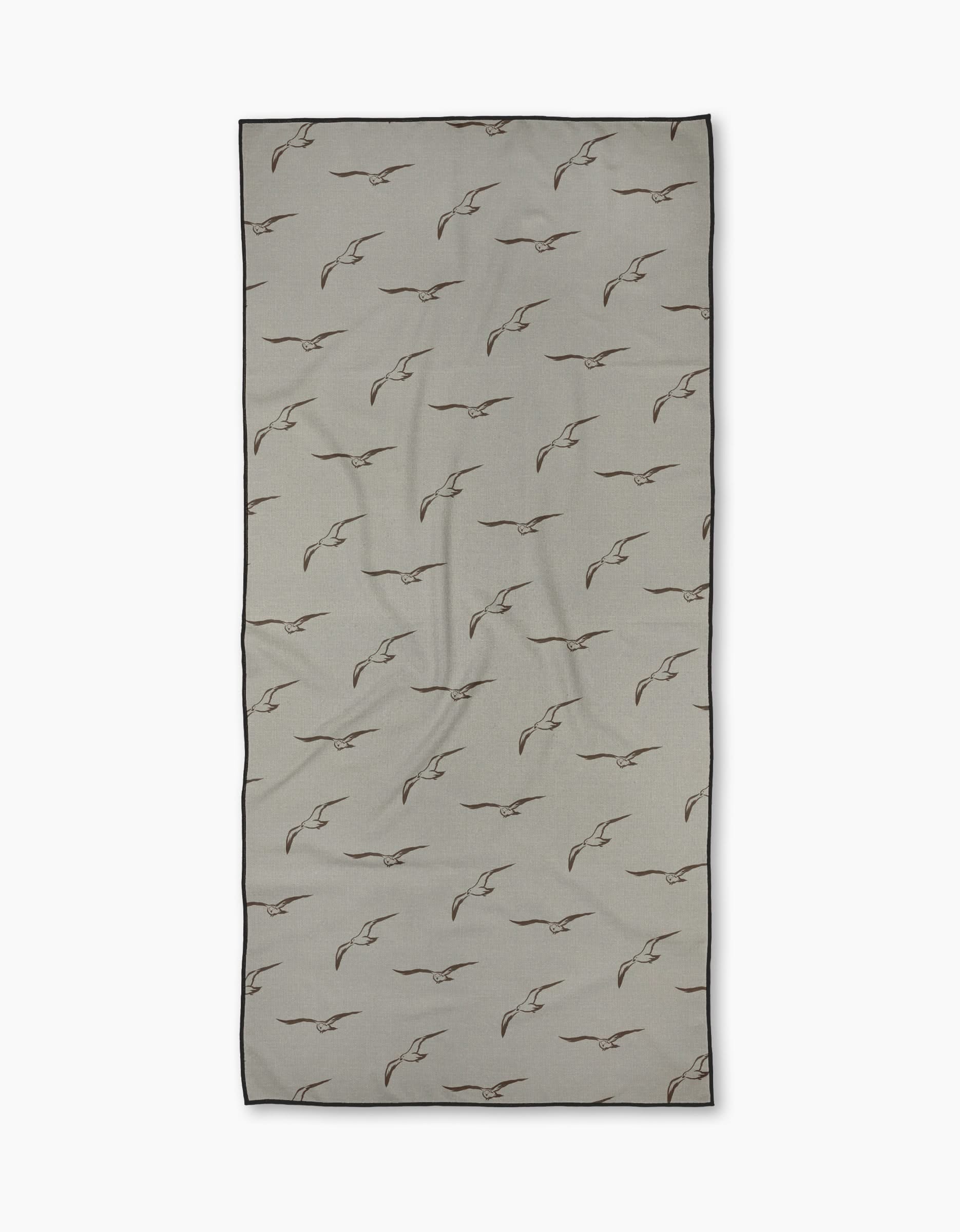 The Shoreline Scout by Jenny Keller is a rectangular beige Geometry Micro-loop Beach Towel made from recycled materials, featuring a brown bird pattern, shown neatly on a white background.