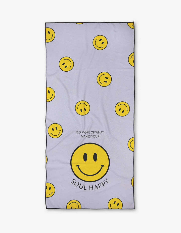 The Soul Happy Micro-loop Beach Towel by Quotes by Christie features scattered yellow smiley faces on light purple, with a large central smiley above “DO MORE OF WHAT MAKES YOUR SOUL HAPPY.” Made from quick-drying recycled materials.