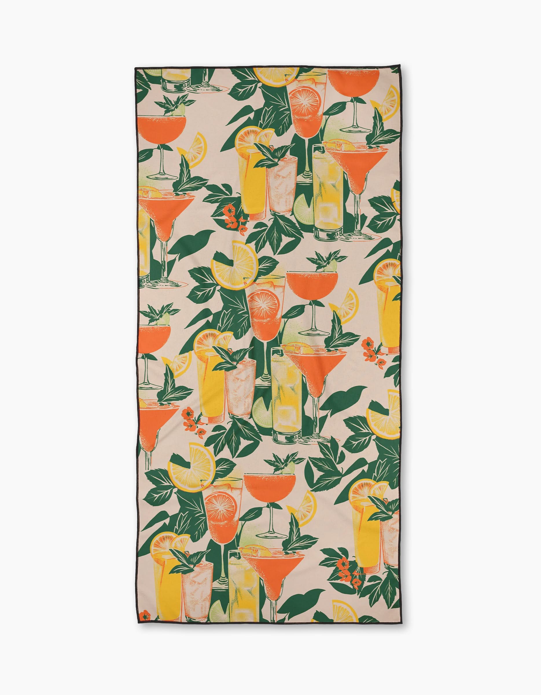 The Geometry “Summer Refreshments” beach towel is quick-drying and rectangular, featuring a colorful pattern of cocktails, lemon and orange slices, and green leaves on a light background.