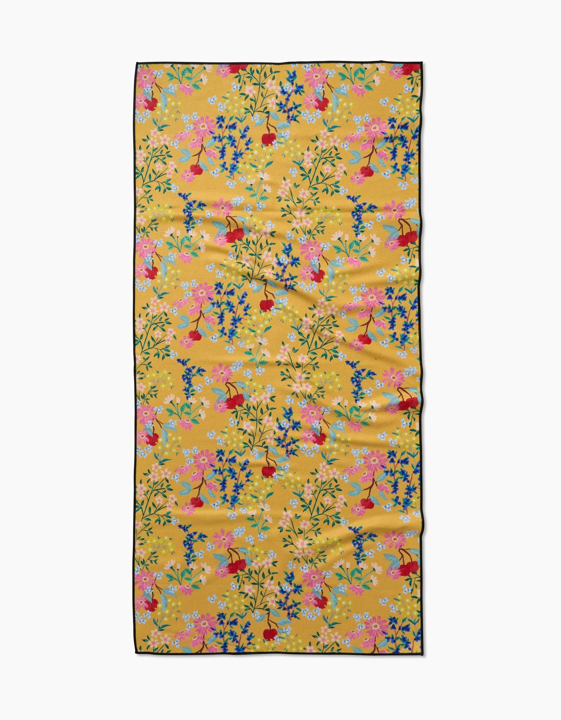 The Sunny Cherry Blossoms towel by Brittany Jepsen is a rectangular yellow compact beach towel, decorated with colorful floral and bird patterns in pink, blue, and red, plus a thin black border. Quick-drying and perfect for the beach.