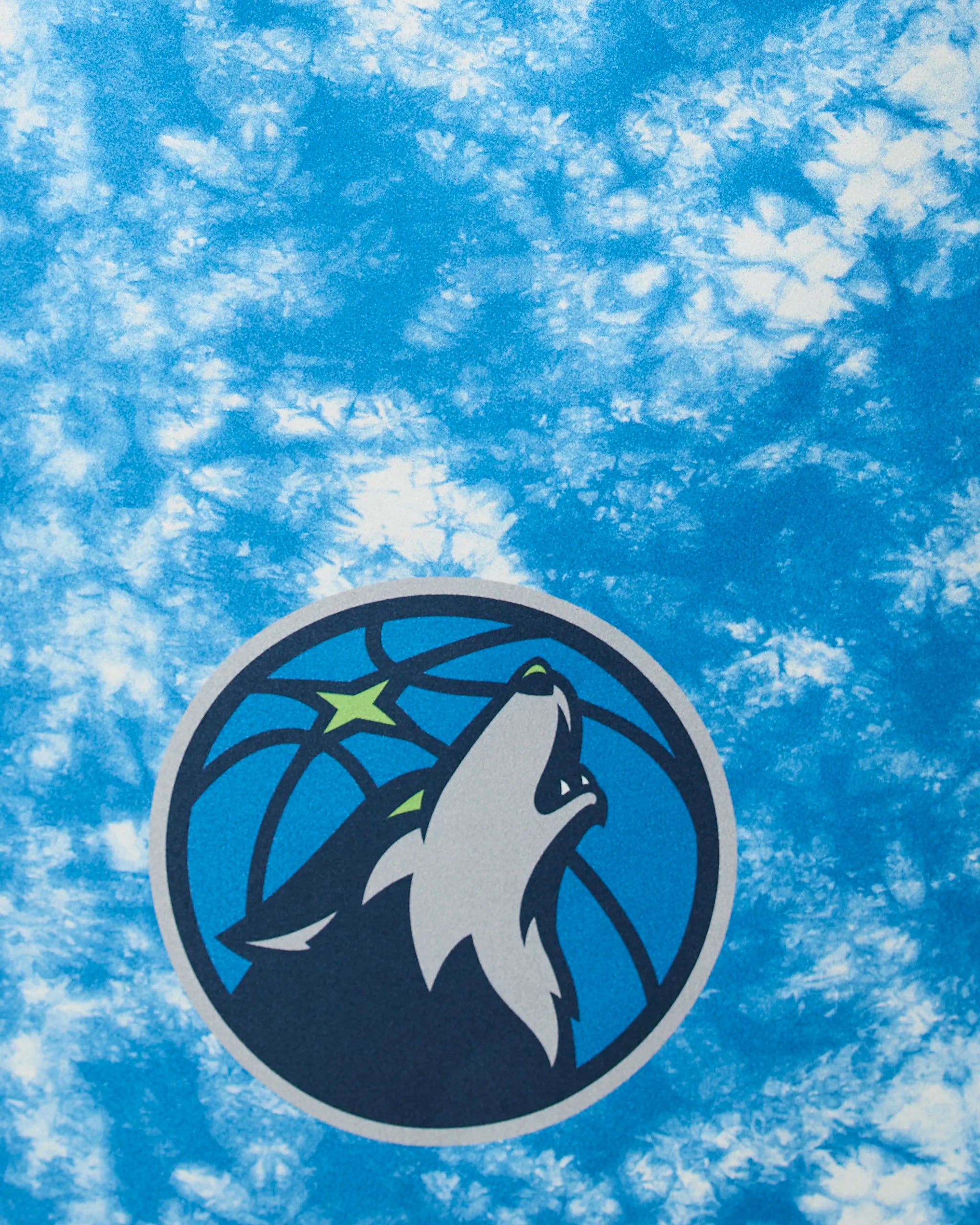 The image displays the Timberwolves Flash by Geometry, featuring the Minnesota Timberwolves logo—a wolf howling before a basketball with two green stars—on a blue and white tie-dye background.