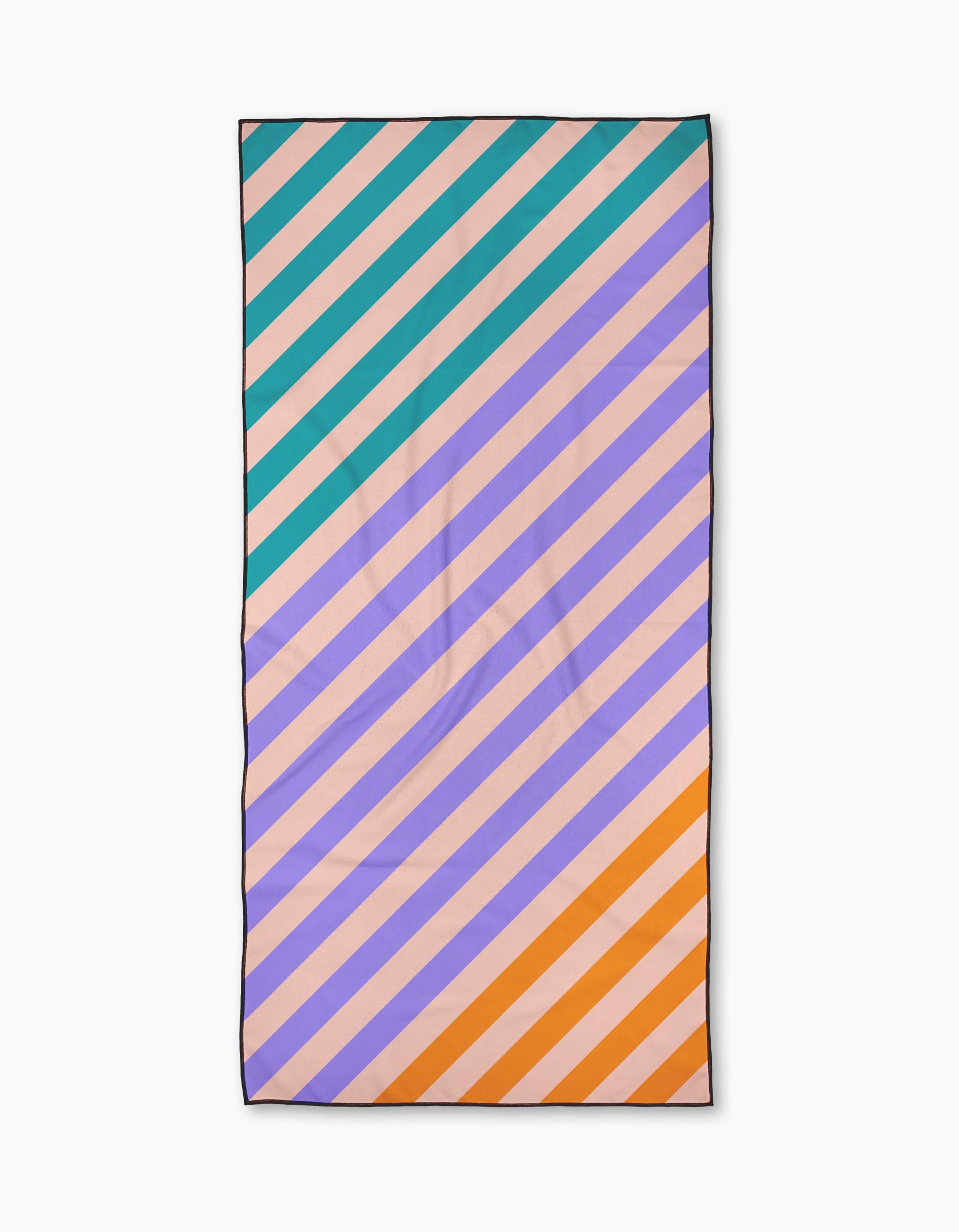 The Geometry Tropical Mirage is a rectangular micro-loop beach towel with diagonal turquoise, lavender, peach, and orange stripes on a light background. Quick-drying with a thin dark border, it’s perfect for days at the pool or beach.