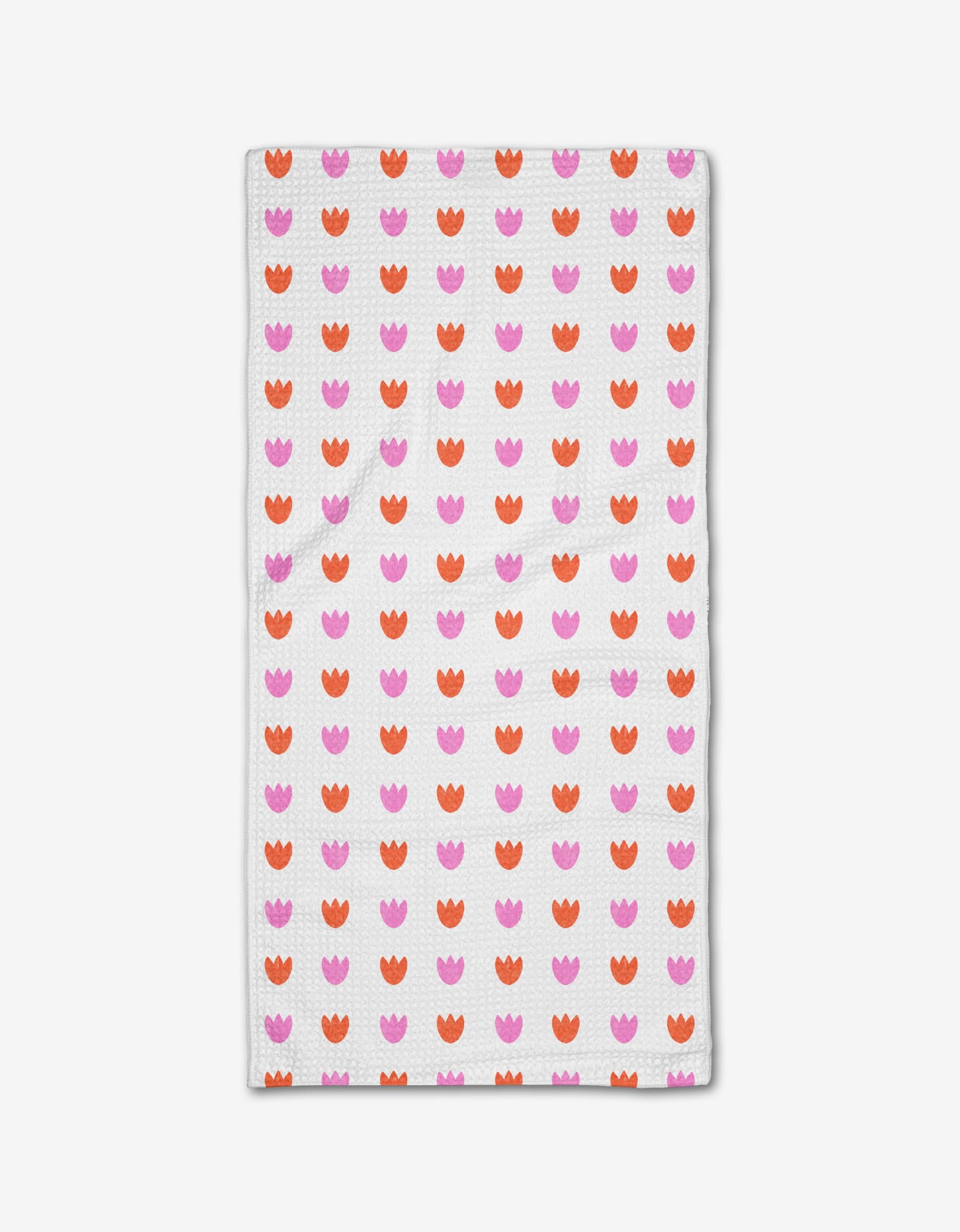 The Addison bar towel by Amy MacCready is a rectangular white towel featuring rows of pink and orange tulip-like shapes, crafted from innovative Geoweave fabric.