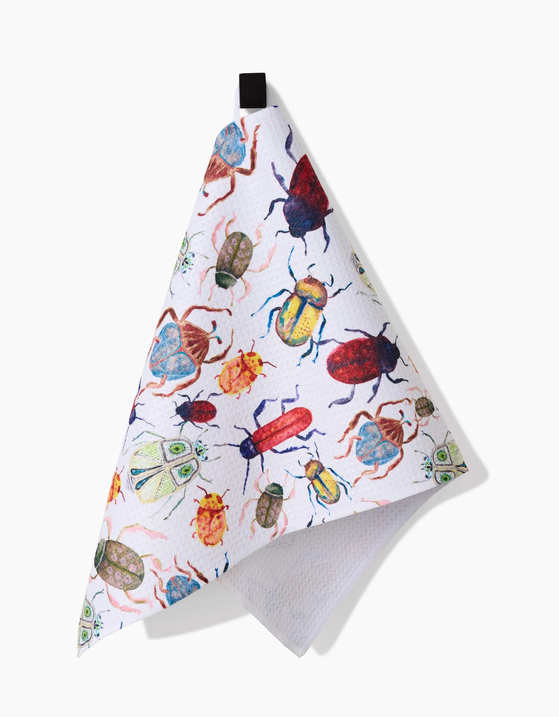 The African Beetles Bar Towel by Taryn Brennan features colorful, detailed insect illustrations on Geoweave fabric and hangs from a black loop against a white background.
