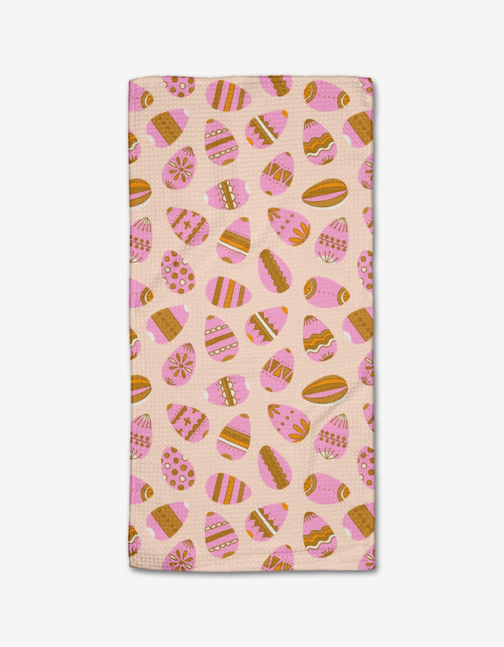 The Arledge Bar Towel by Amy MacCready is crafted with Geoweave fabric and features pink, orange, and brown Easter eggs and cookies on a light beige background.