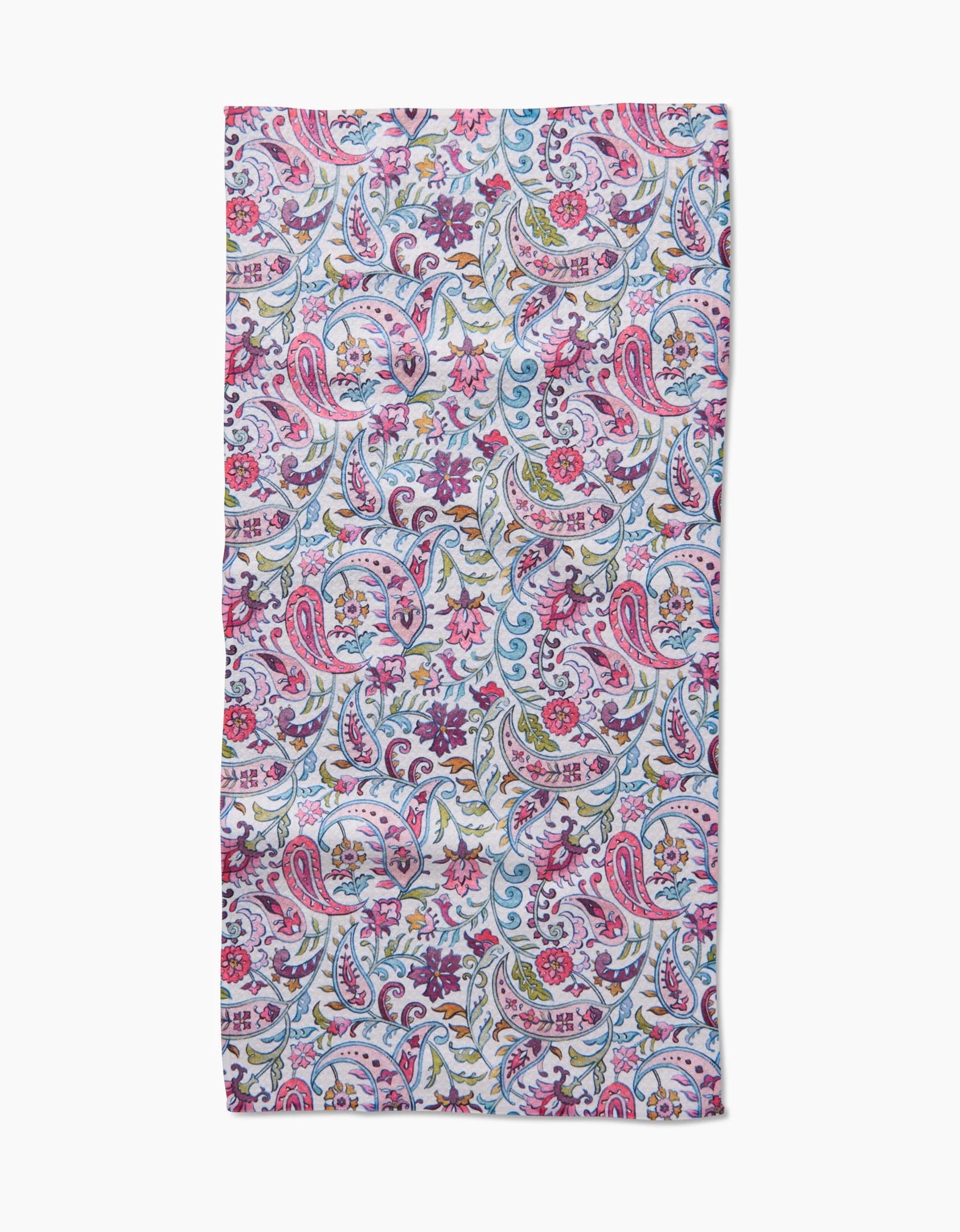 The Bazaar bar towel by Maayan Alper-Swan is made from ultra-absorbent Geoweave fabric, showcasing a vibrant floral and paisley design in pink, blue, green, and white tones. It is displayed flat on a white background.