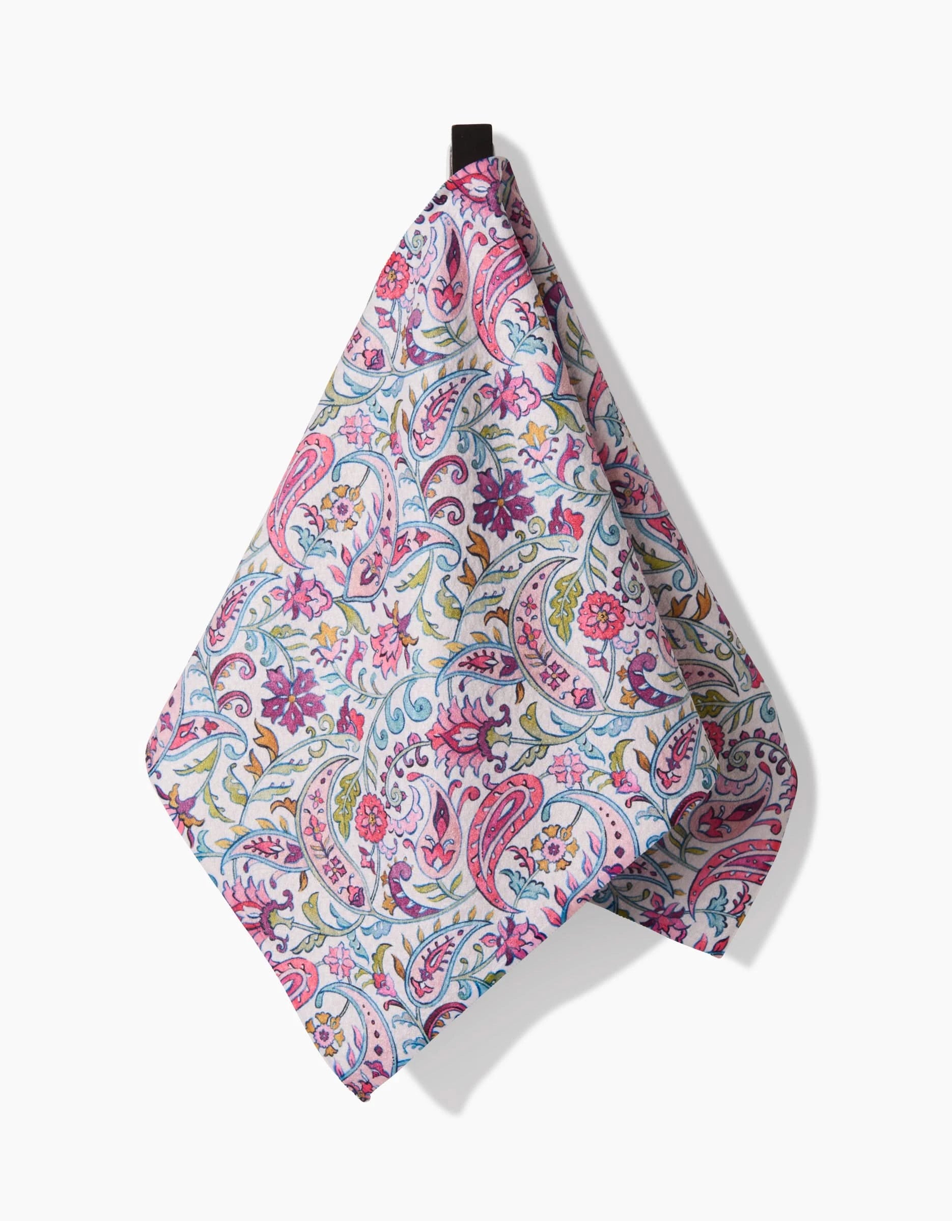 The Bazaar towel by Maayan Alper-Swan features a colorful paisley and floral design in pink, blue, green, and yellow. Made from ultra-absorbent Geoweave fabric, it hangs by a small black loop against a white background.